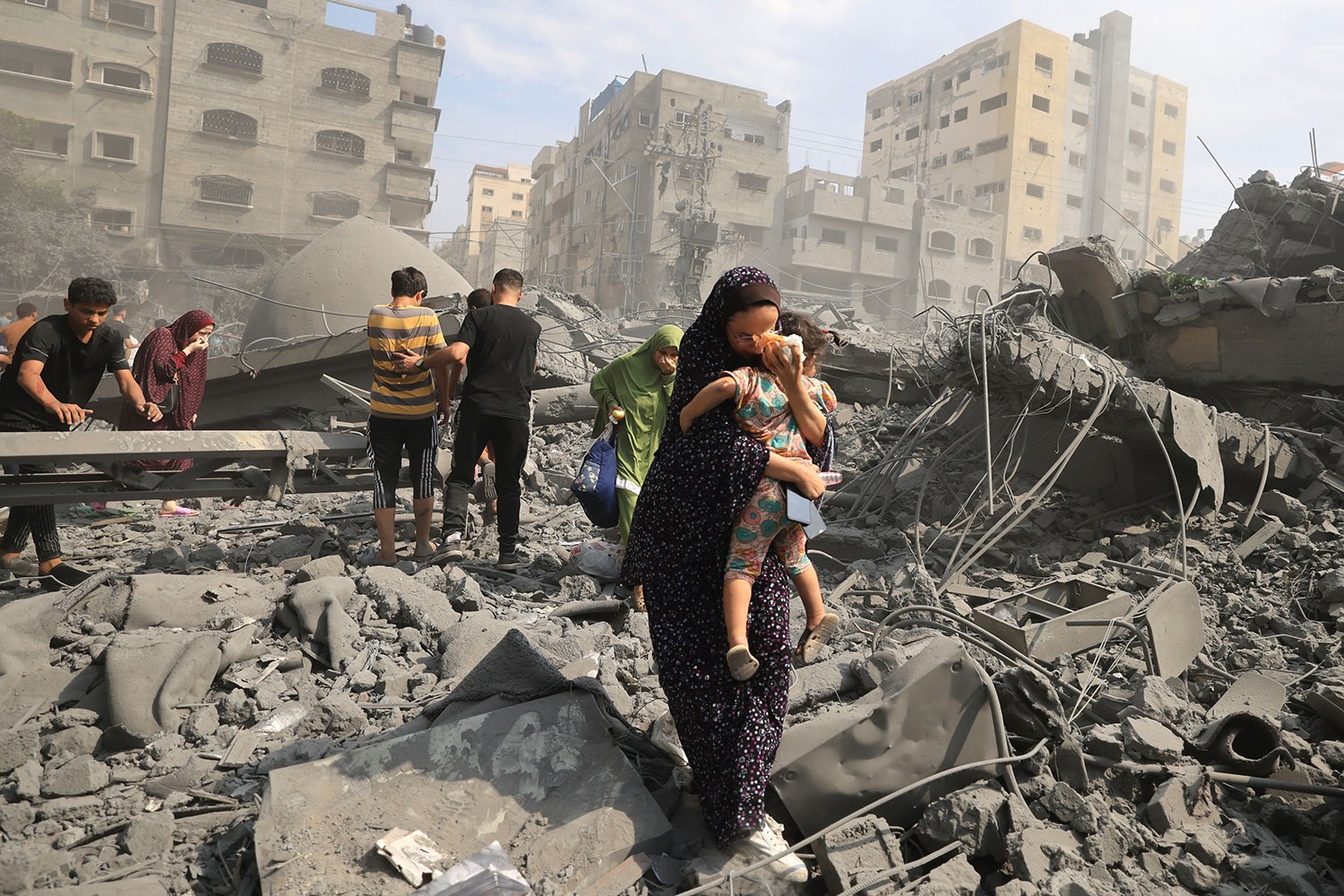 Palestinians evacuate following an Israeli airstrike on the Sousi Mosque in Gaza on October 9. (AFP)
