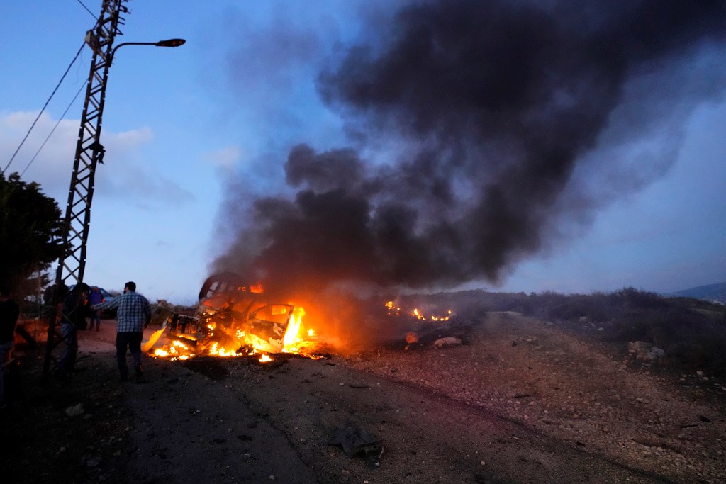A journalist's car burns after it was hit by Israeli shelling in the Alma al-Shaab border village with Israel, South Lebanon, Friday, Oct. 13, 2023 (AP Photo/Hassan Ammar)