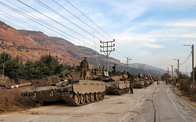 A column of Israeli Merkava battle tanks is amassed in upper al-Jalil near the border with Lebanon on October 11, 2023. (AFP)