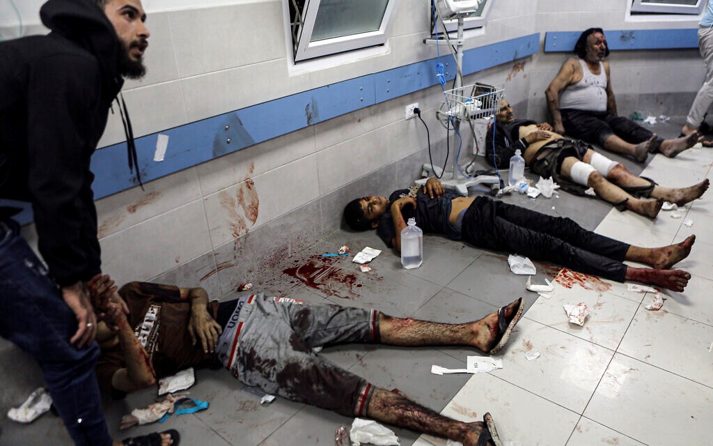 Wounded Palestinians lie on the floor in al-Shifa Hospital in Gaza City, central Gaza Strip, after arriving from al-Ahli Hospital following an explosion there, Tuesday, Oct. 17, 2023. (AP)