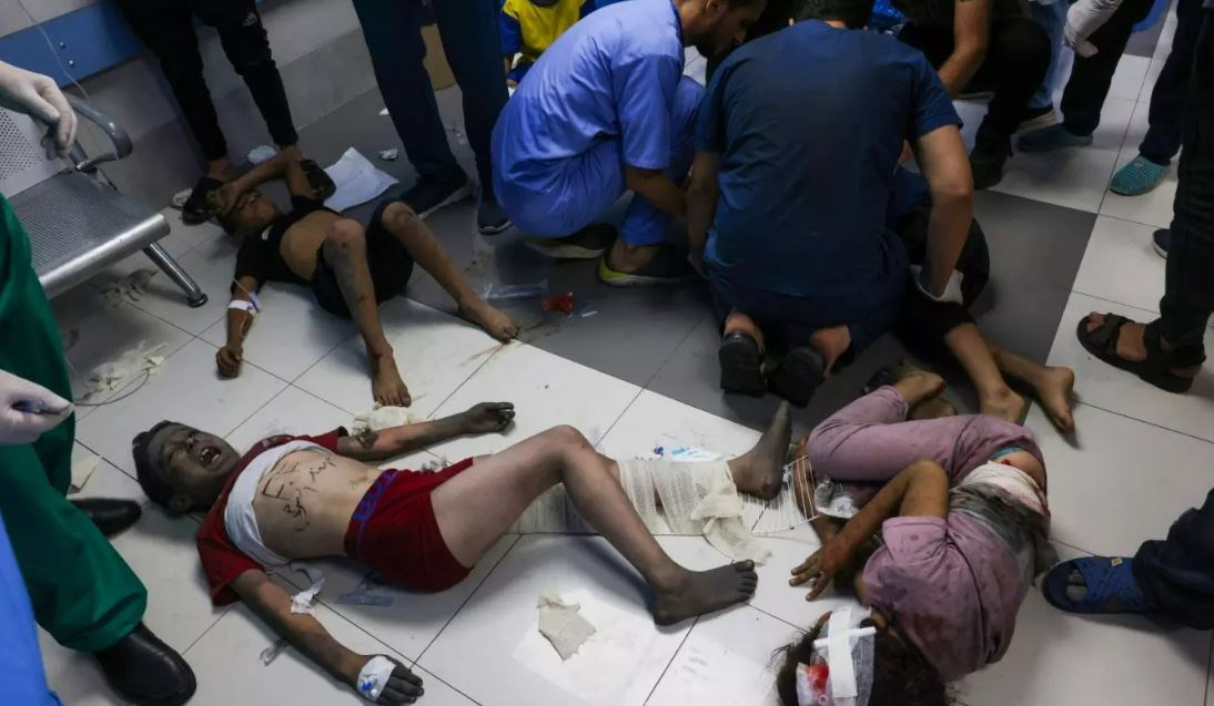 Palestinian medics tend to children wounded by Israeli air strikes at al-Shifa hospital in Gaza City on 11 October 2023. (AFP)