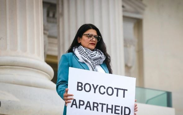 Rep. Rashida Tlaib, D-Mich., holds a sign that reads “boycott apartheid” outside the US Capitol on July 17, 2023. (AP)