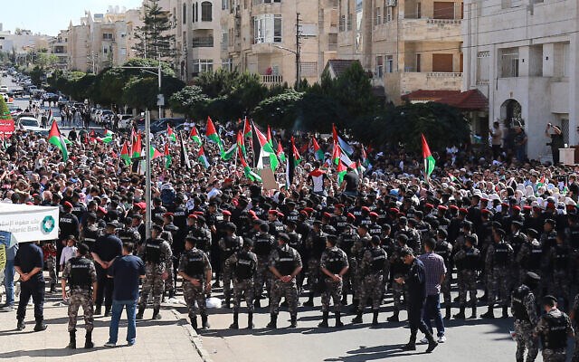 Demonstrators chant slogans near the Israeli Embassy in Amman on October 20, 2023. (AFP)