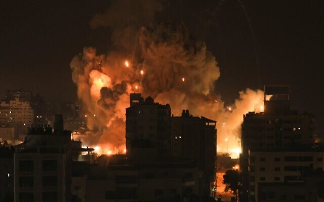 Fire and smoke rise above buildings in Gaza City during an Israeli airstrike on October 8, 2023 (AFP)