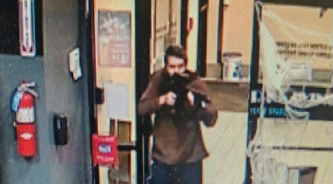 In this image taken from video released by the Androscoggin County Sheriff's Office, an unidentified shooter points a gun while entering Sparetime Recreation in Lewiston, Maine, on Wednesday, Oct. 25, 2023. (AP)