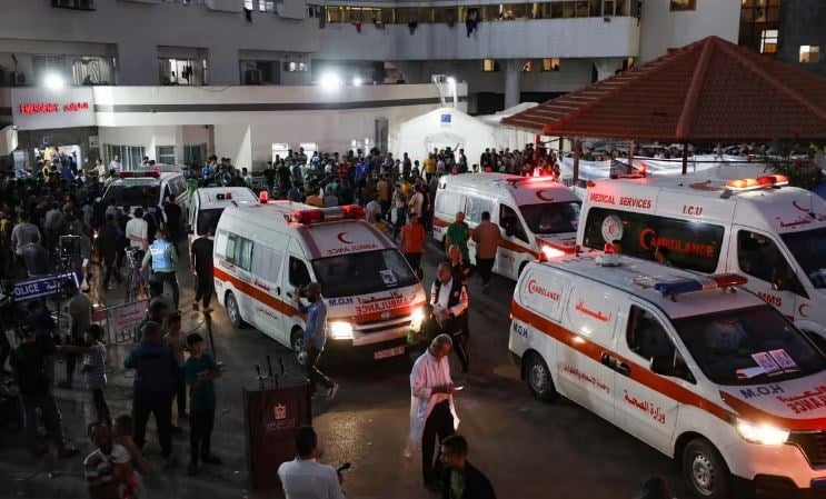 Ambulances carrying victims of Israeli strikes crowding the entrance to the emergency ward of Al-Shifa hospital on October 17. (AFP via Getty Images)