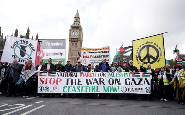 Protesters hold a banner during a pro-Palestinian march, in central London, October 28, 2023. (AP)