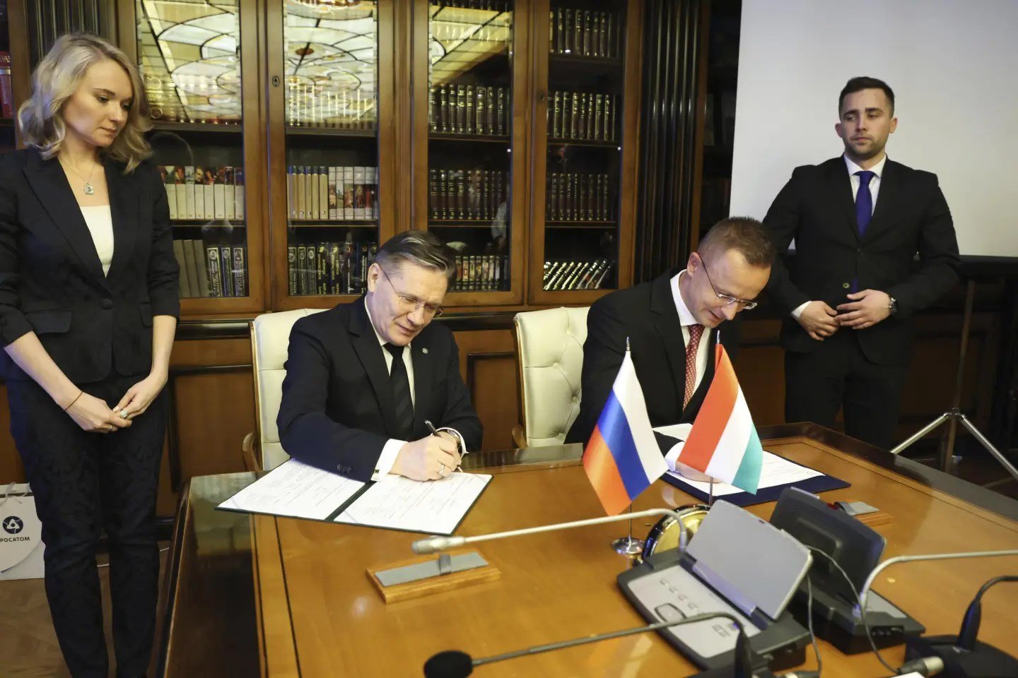 Hungarian FM Peter Szijjarto and Director General of Rosatom Alexey Likachev in April 2023 in Moscow signing an agreement (AP)