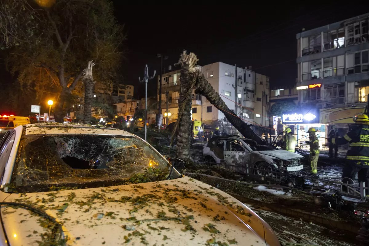 Fire crews work at the site where a rocket fired from the Gaza Strip hits 'Tel Aviv'. (AP)