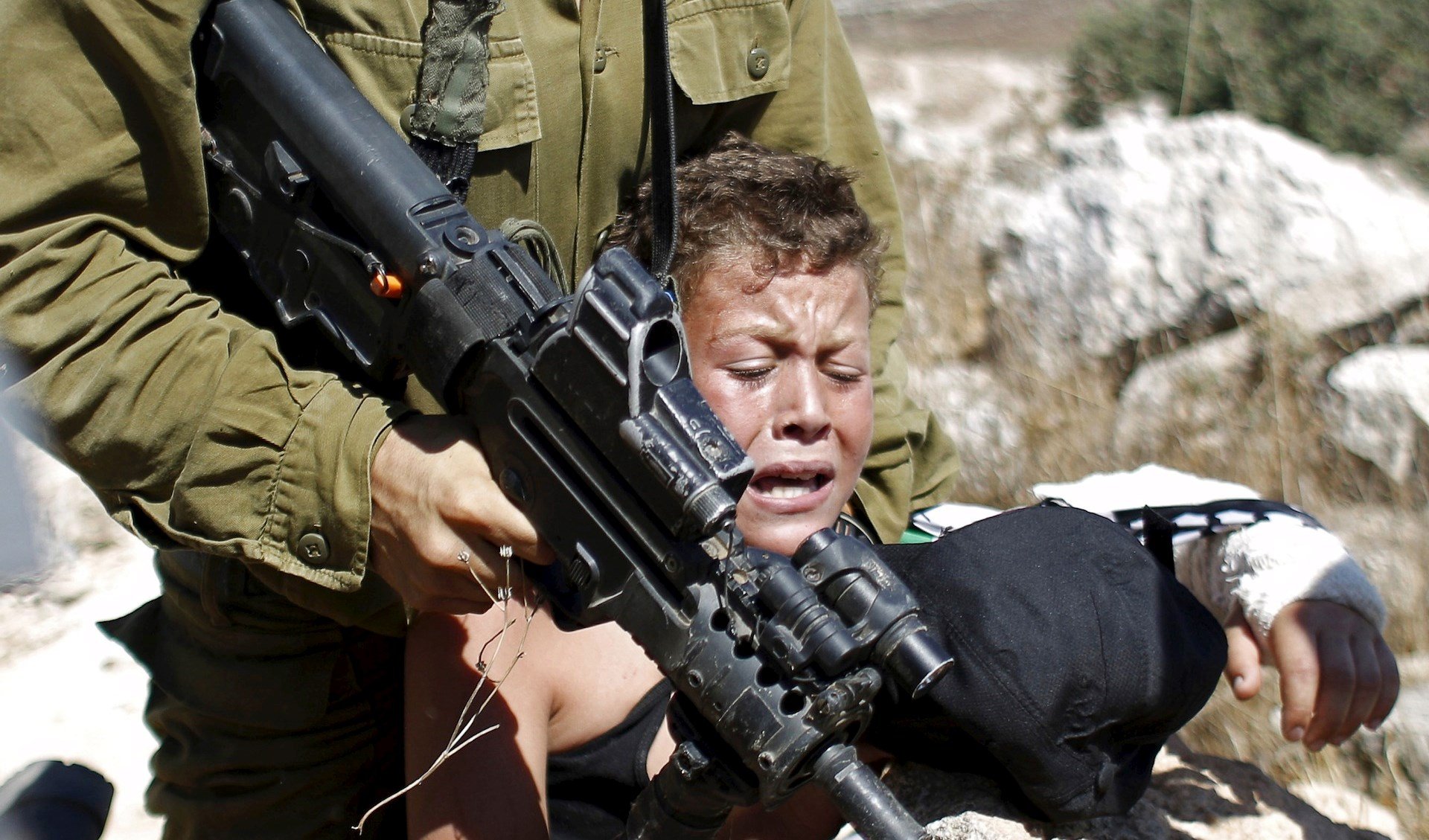 IOF tries to restrain a Palestinian boy in Ramallah, Palestine August 28, 2015 (Reuters).