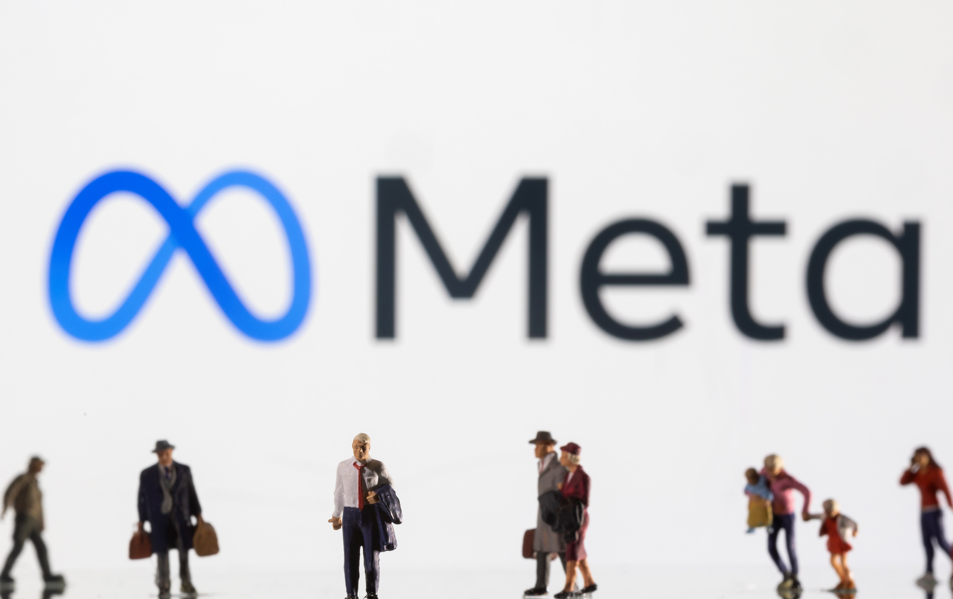 Small figurines are seen in front of displayed Meta logo in this illustration taken February 11, 2022. (Reuters)