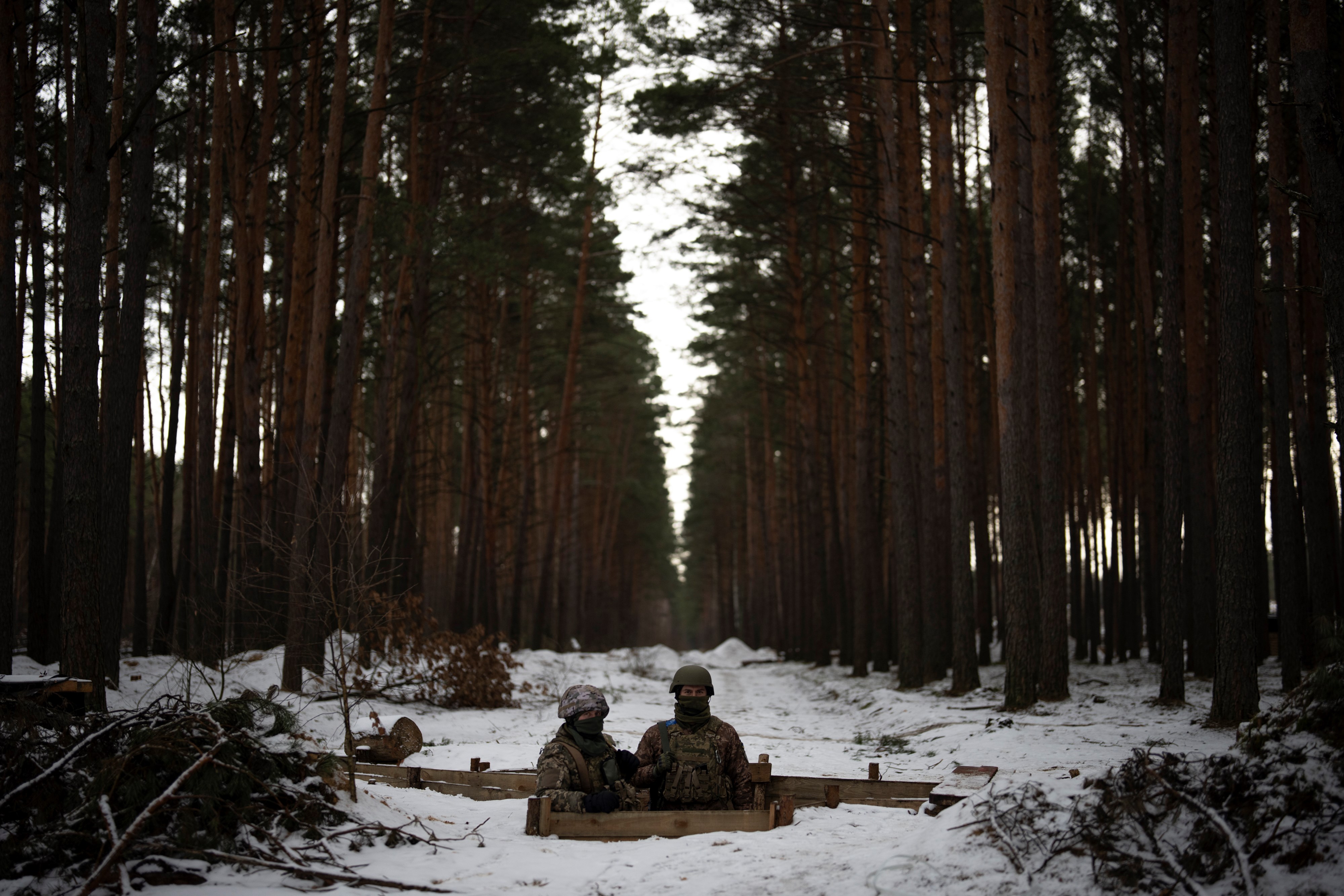 Ukrainian servicemen stand at a position close to the border with Belarus, Ukraine, Wednesday, Feb. 1, 2023 (AP Photo/Daniel Cole)