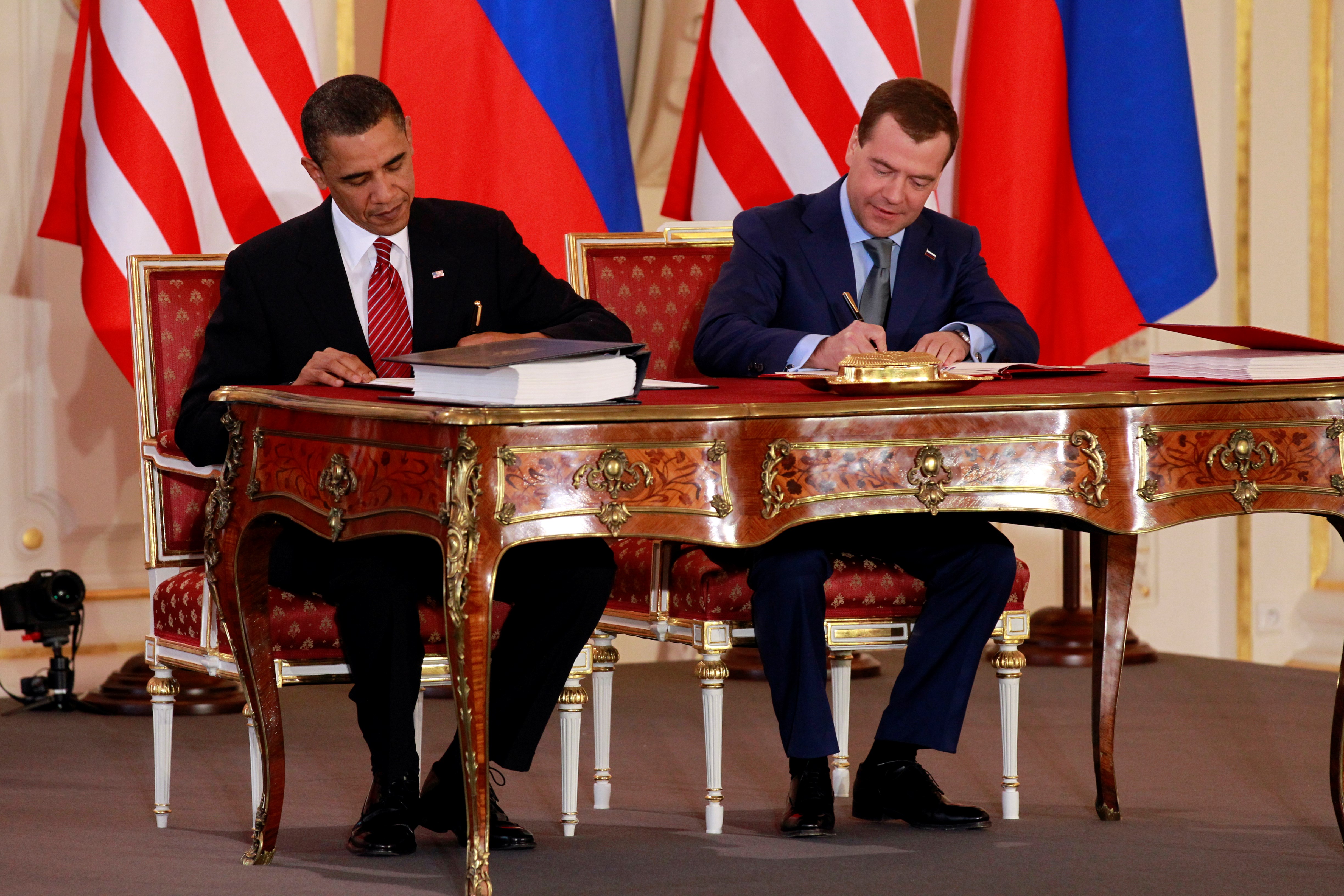 President Barack Obama, left, and Russian President Dmitry Medvedev sign the New START treaty at the Prague Castle in Prague on April 8, 2010 (AP Photo/Alex Brandon, File)