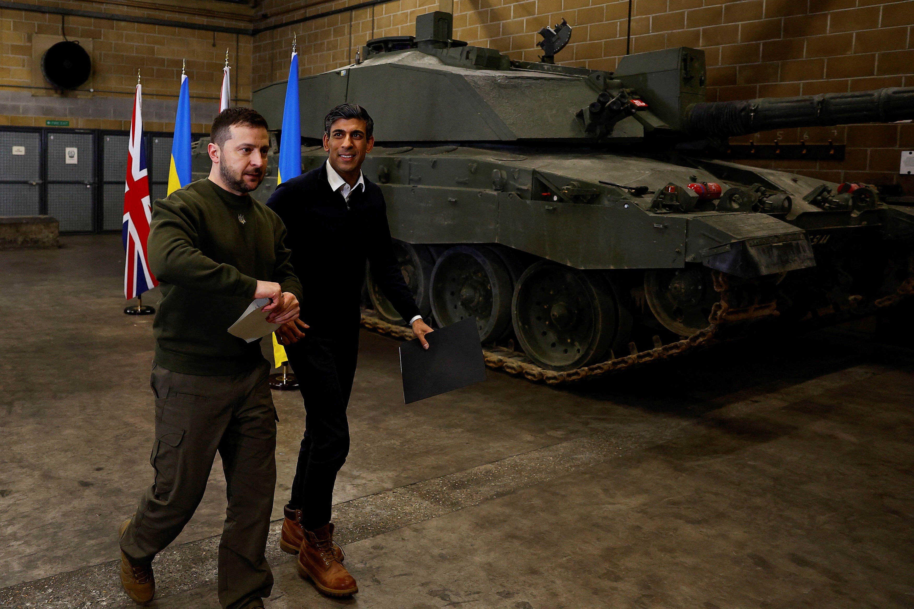 British Prime Minister Rishi Sunak and Ukrainian President Volodymyr Zelenskyy walk after a news conference at a military facility in Lulworth, Dorset, England, Wednesday Feb. 8, 2023 (Peter Nicholls/Pool via AP)