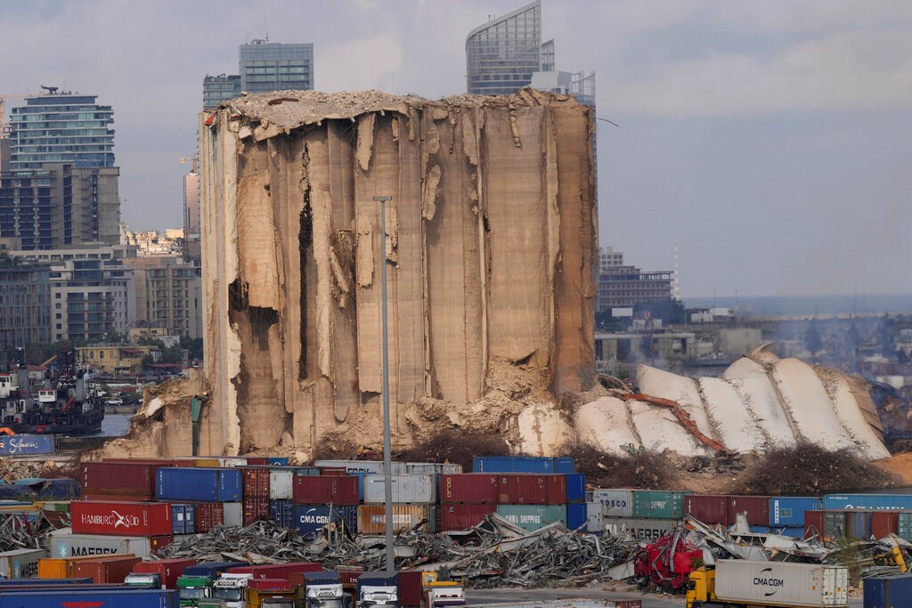 A collapsed portion, right, lies on the ground of the silos that damaged during the August 2020 massive explosion in the port, in Beirut, Lebanon, Tuesday, Aug. 23, 2022 (AP Photo/Hussein Malla)