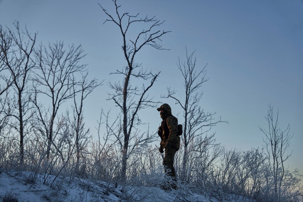 A Ukrainian soldier looks on in his position in the frontline close to Bakhmut, Donetsk region, Thursday, Feb. 9, 2023 (AP Photo/Libkos)