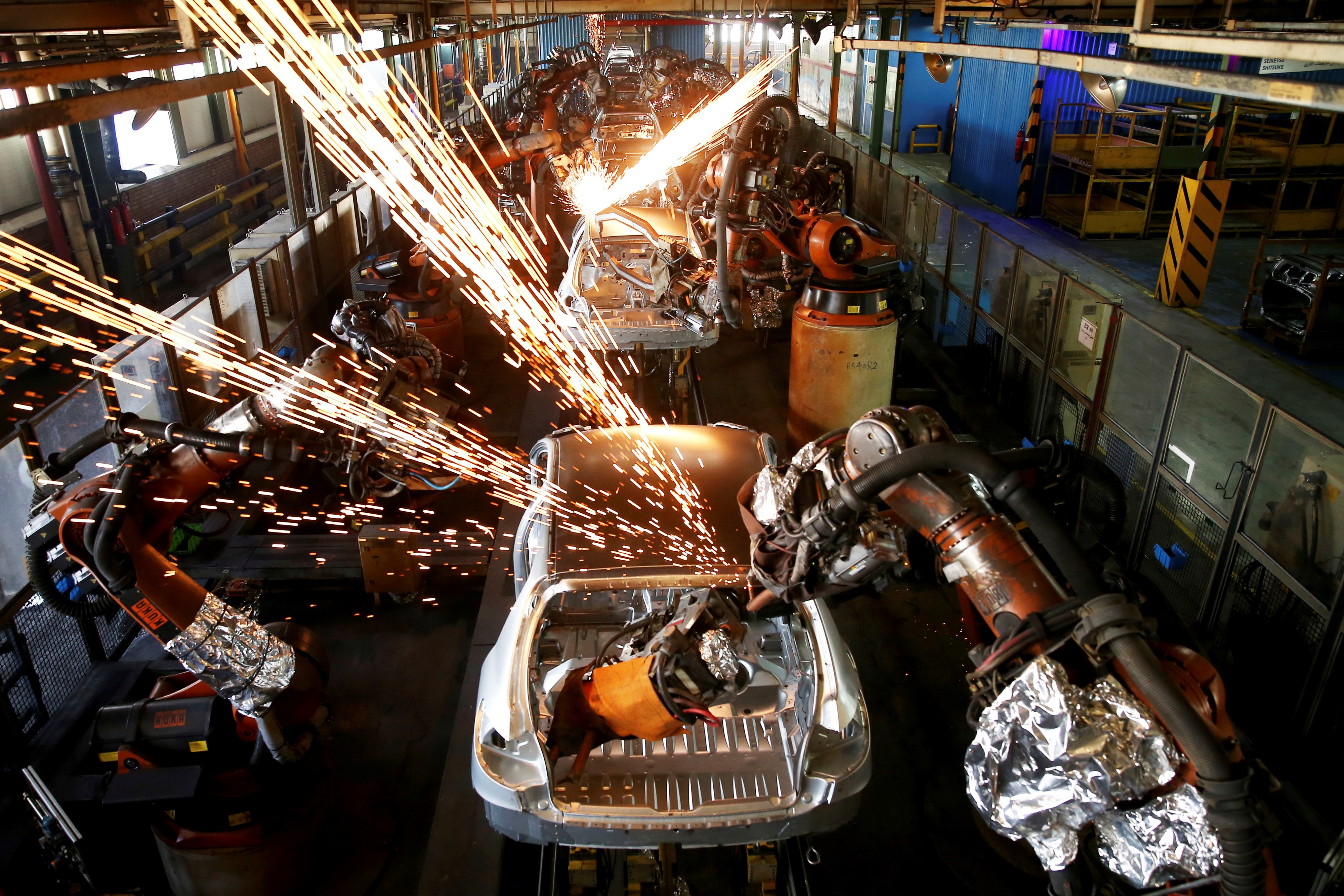 In this Sunday, Sept. 9, 2018 photo, bodies of cars gothrough an assembly line at the Iran Khodro automobile manufacturing plant, just outside Tehran, Iran (AP Photo/Ebrahim Noroozi)