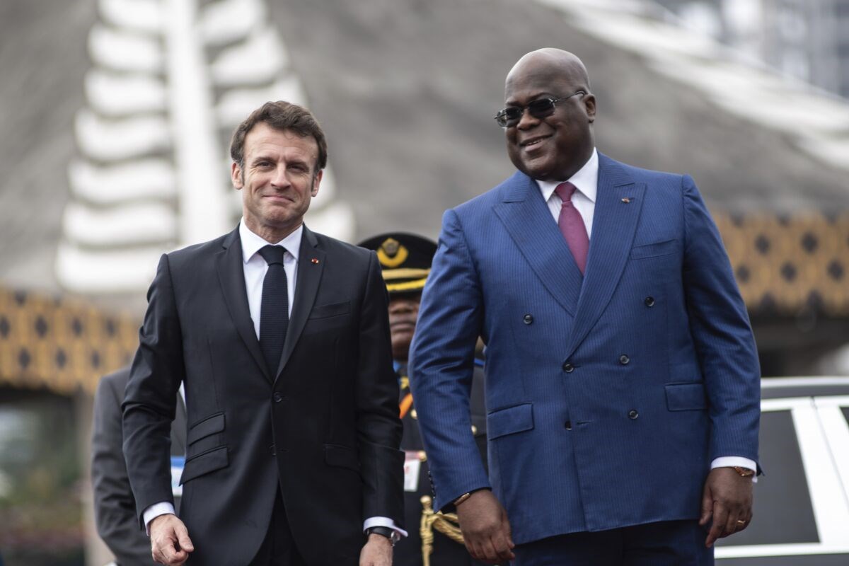 French President Emmanuel Macron, left, is greeted by Democratic Republic of the Congo President Felix Tshisekedi in Kinshasa on Saturday March 4, 2023. (AP)