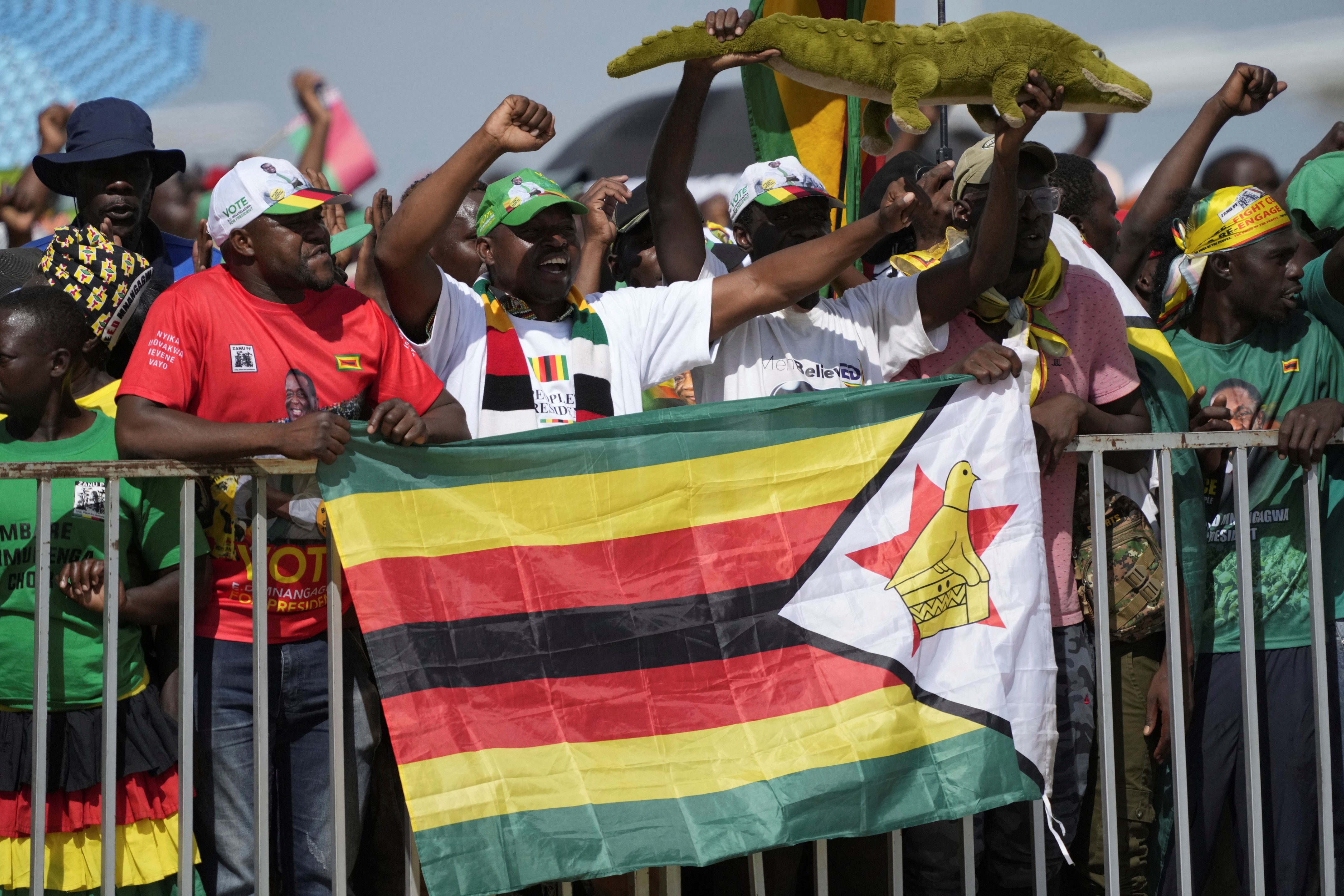 Supporters of Zimbabwe's ruling party sing and cheer while welcoming Belarus President Alexander Lukashenko upon his arrival at Robert Mugabe International airport in Harare, Monday, Jan, 30, 2023 (AP /Tsvangirayi Mukwazhi)