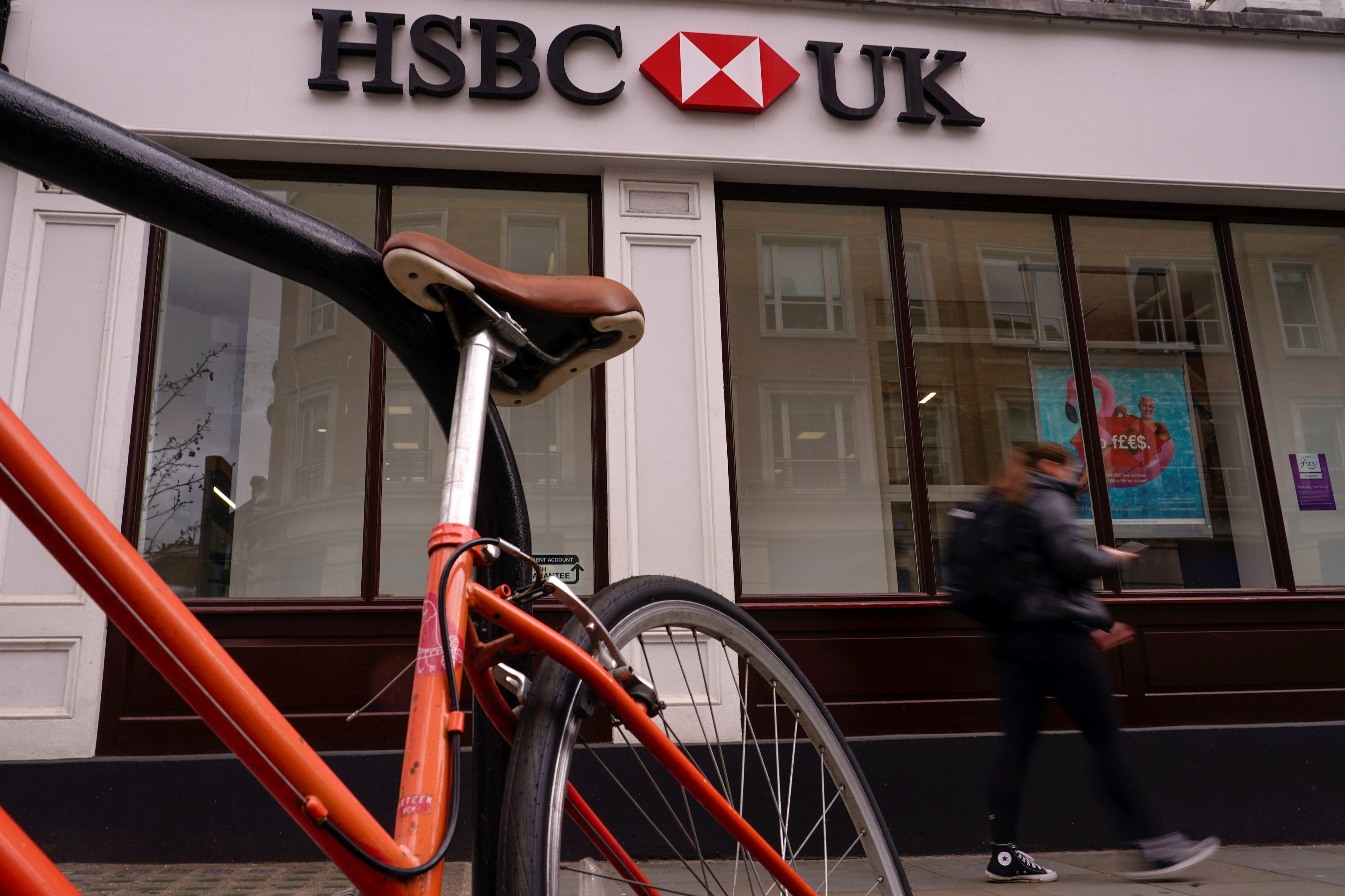 A person walks past an HSBC branch, in London, Monday, March 13, 2023 (AP).