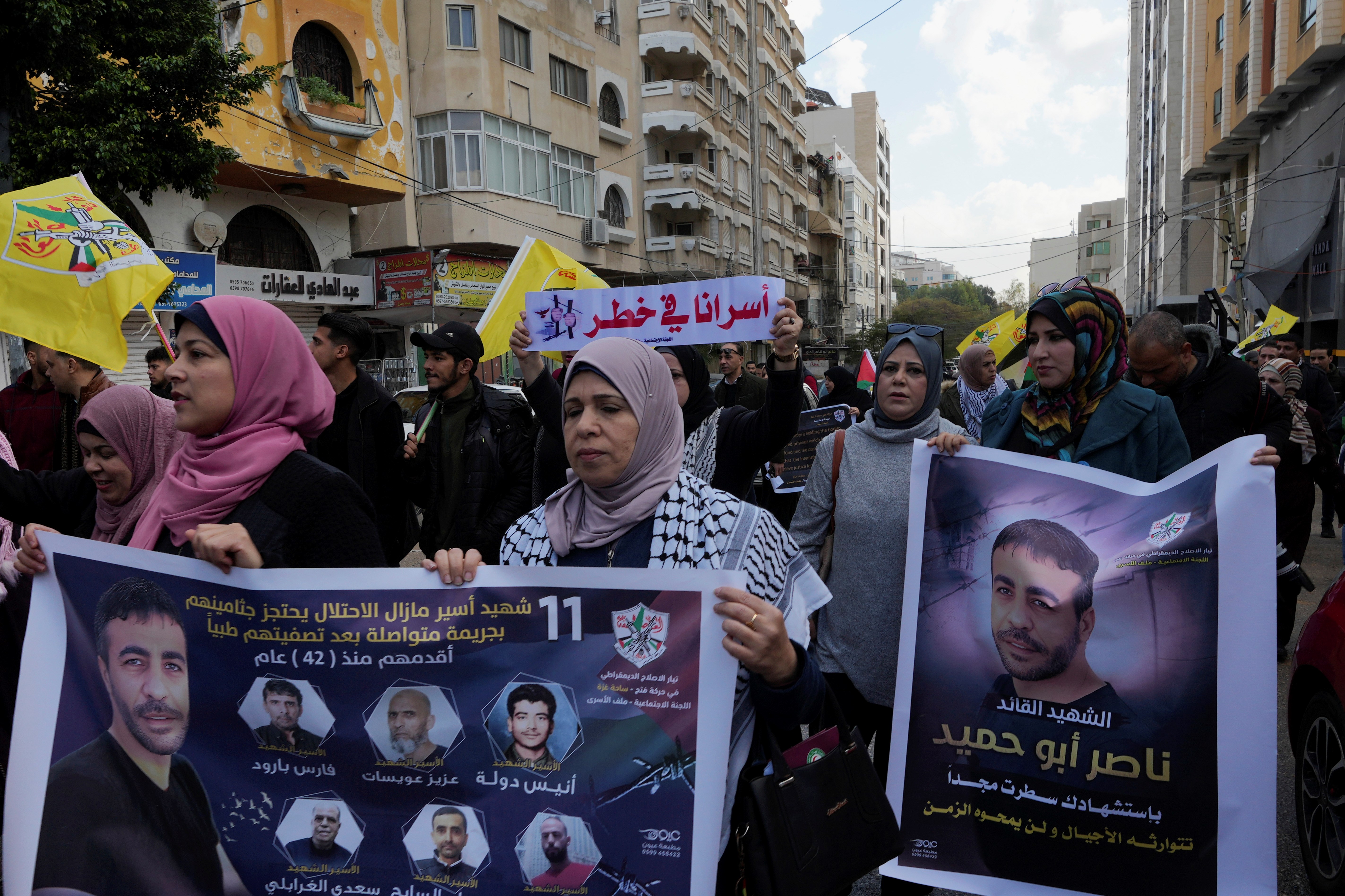 Palestinians march with posters of Nasser Abu Hamid, a veteran Palestinian prisoner who died in Israeli custody last week, in Gaza City, Tuesday, Dec. 27, 2022 (AP Photo/Adel Hana)