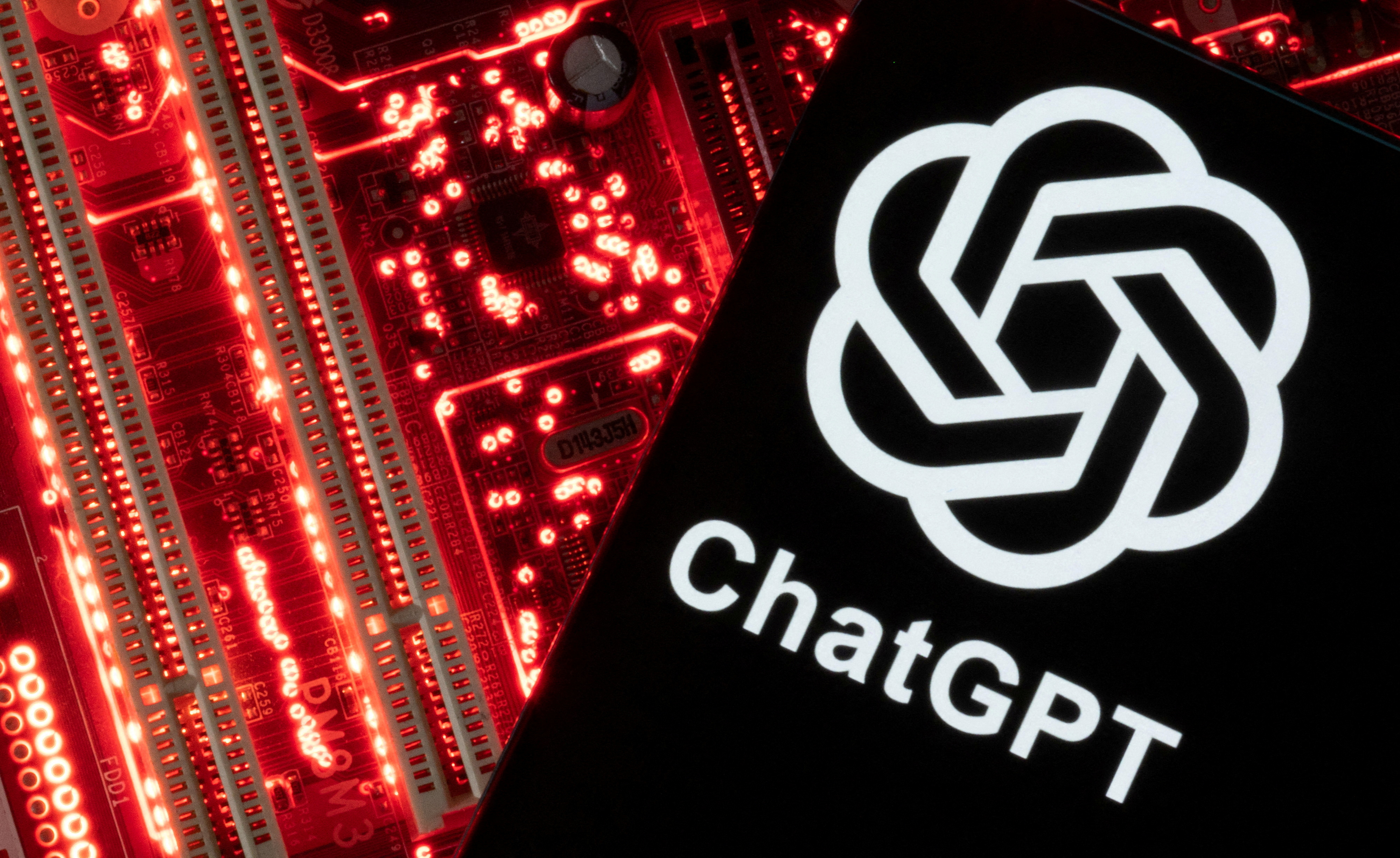 A smartphone with a displayed ChatGPT logo is placed on a computer motherboard in this illustration taken February 23, 2023 (Reuters).