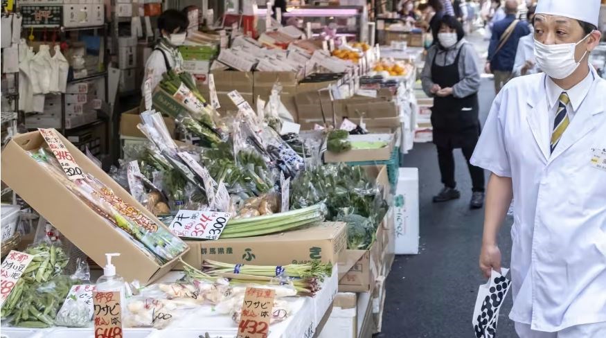 A fishmonger walks through a street market in Tokyo's Tsukiji area on April 22. (AFP)