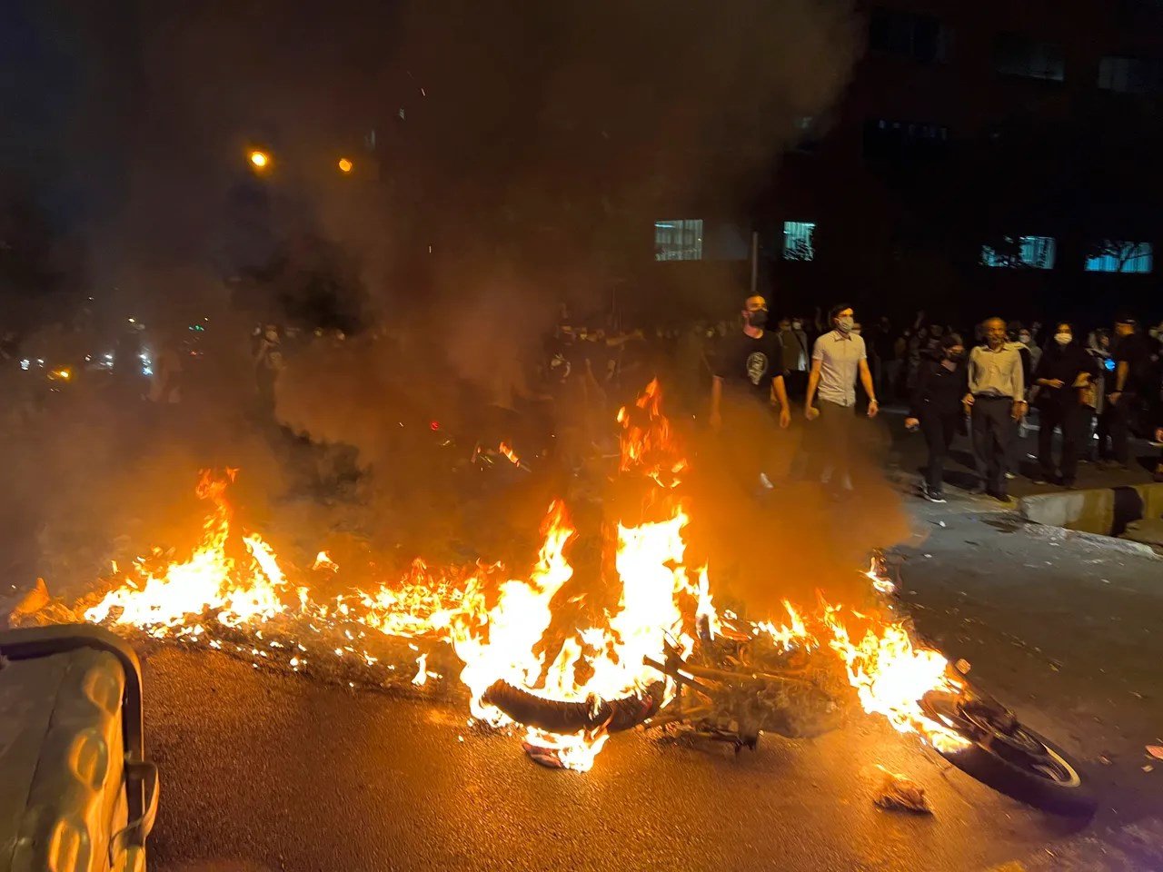 A police motorcycle burns during a protest over the death of Mahsa Amini, September 19 2022 (AP).