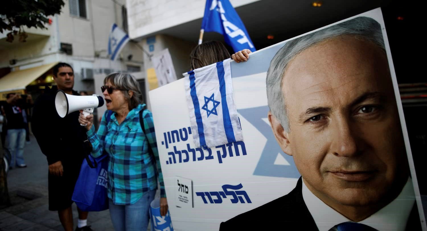 Supporters of Israeli Prime Minister Benjamin Netanyahu. The placards in Hebrew read, “Strong in security, strong in Economy “. Photo credit: REUTERS