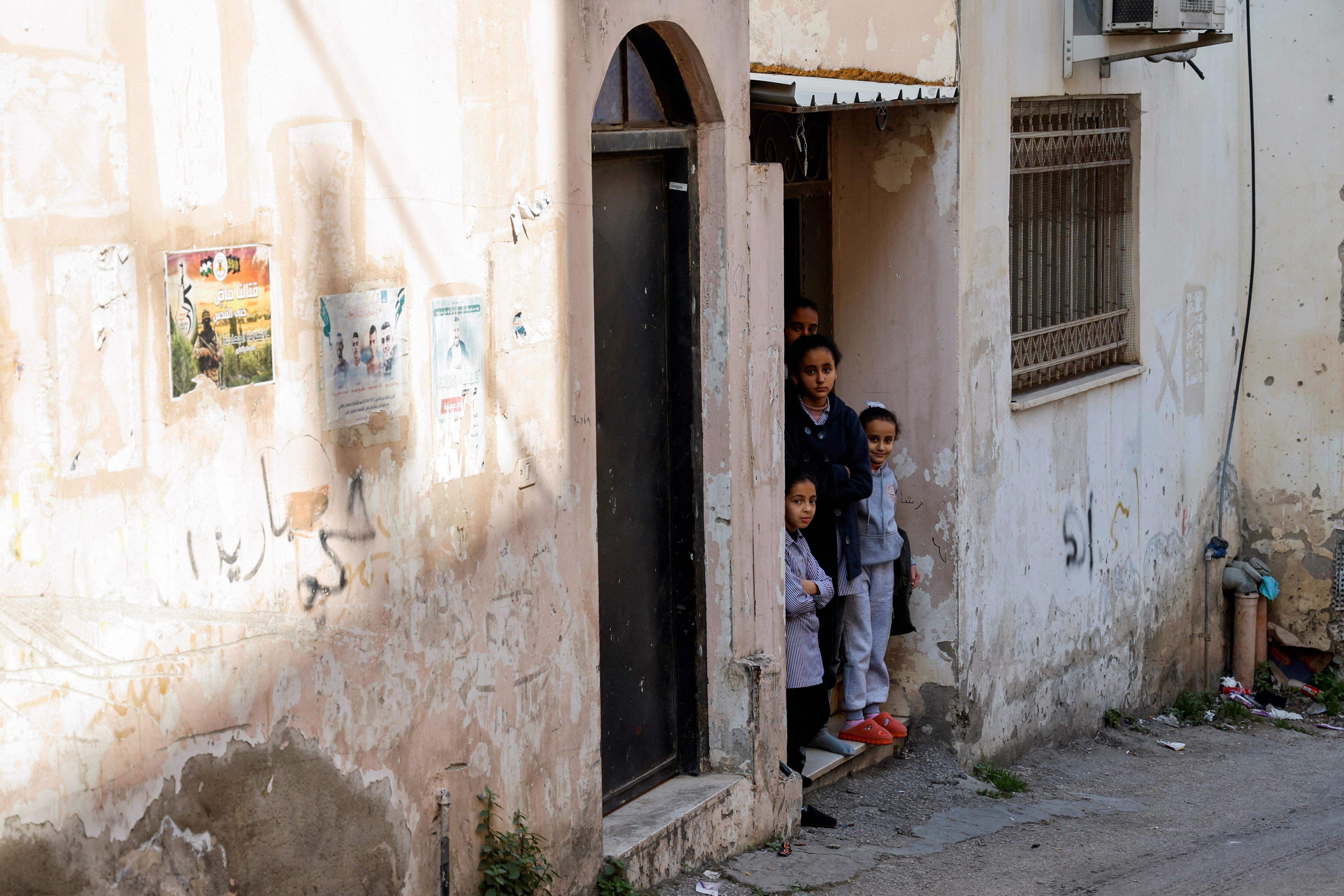 Palestinian children look out of their homes after an Israeli raid in the Jenin refugee camp on January 26, 2023. (Reuters)