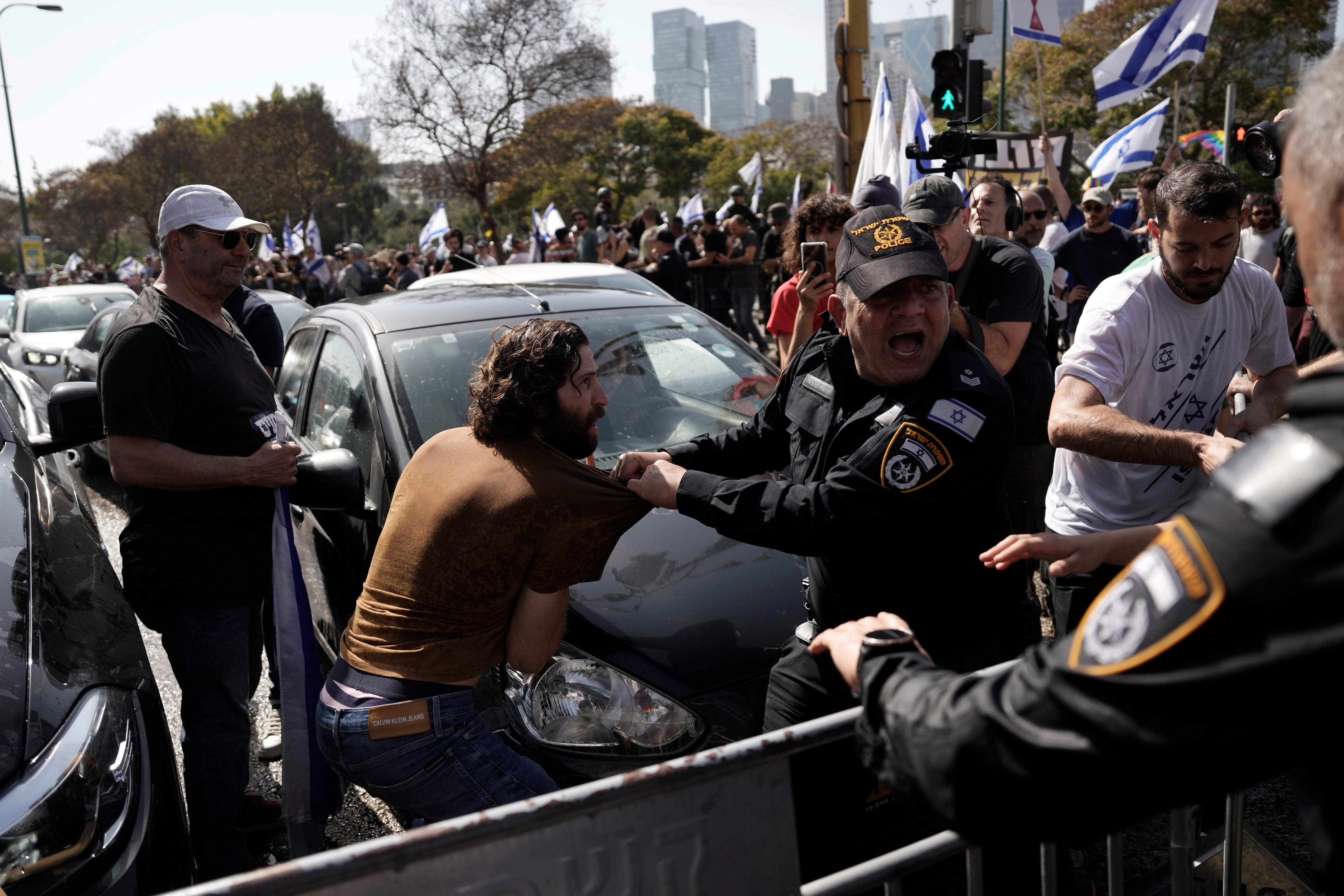 Police scuffle with Israelis blocking a main road to protest against plans by Prime Minister Benjamin Netanyahu's new government to overhaul the judicial system, in Tel Aviv, Israel, Wednesday, March 1, 2023. (AP)