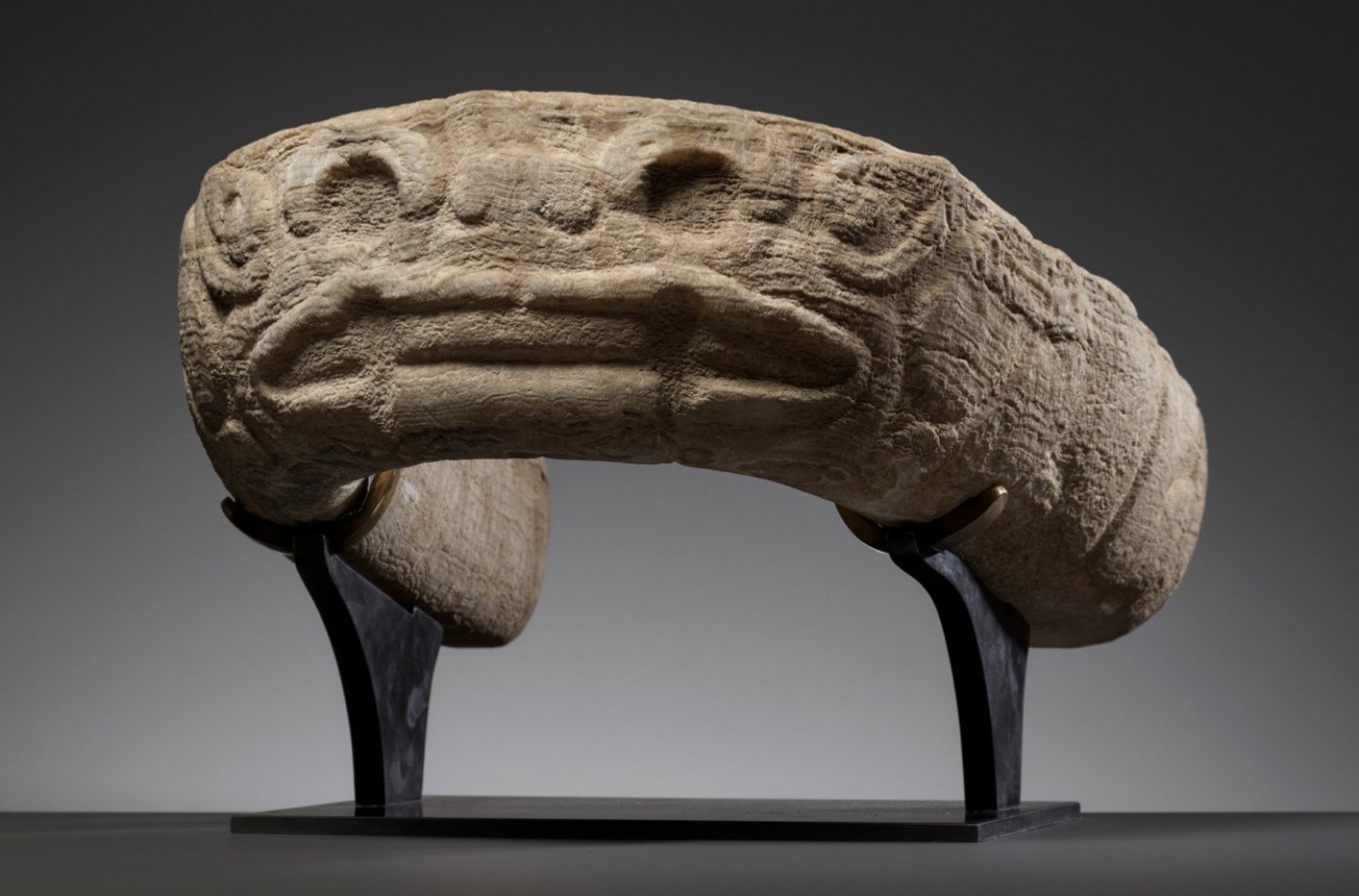 A curved stone carved to depict the Aztec earth god Tlaltecuhtli. (GALERIE ZACKE)