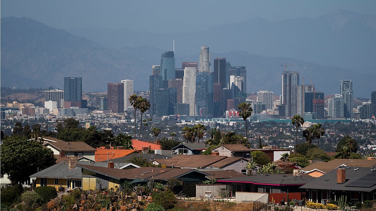 Homes sit on a hilltop with a view of the downtown Los Angeles skyline Thursday, June 10, 2021, in Los Angeles. (AP)