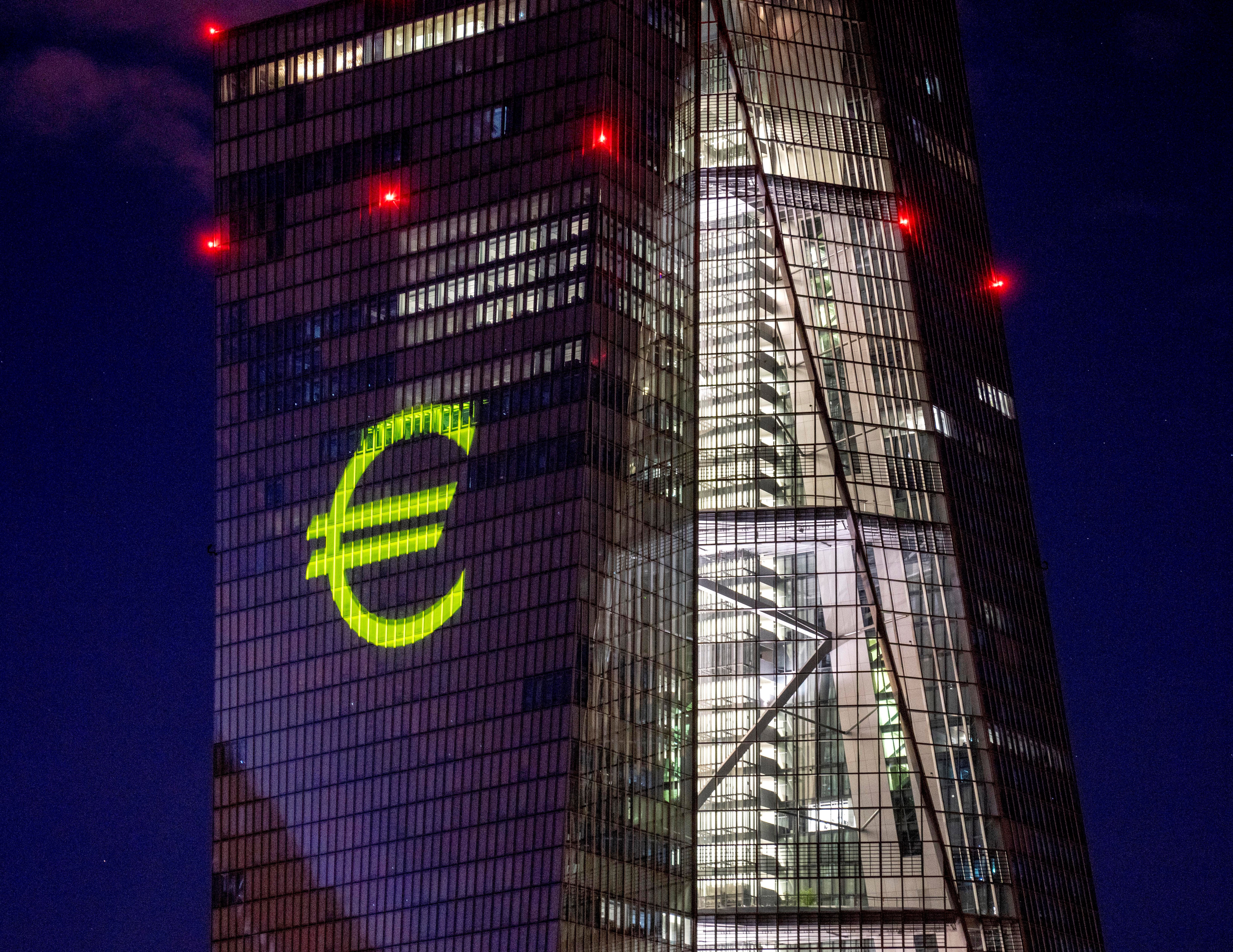 A light installation is projected onto the building of the European Central Bank during a rehearsal in Frankfurt, Germany, December 30, 2021 (AP).