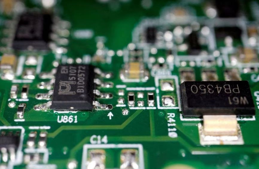Semiconductor chips are seen on a printed circuit board in this illustration picture taken February 17, 2023. (REUTERS)