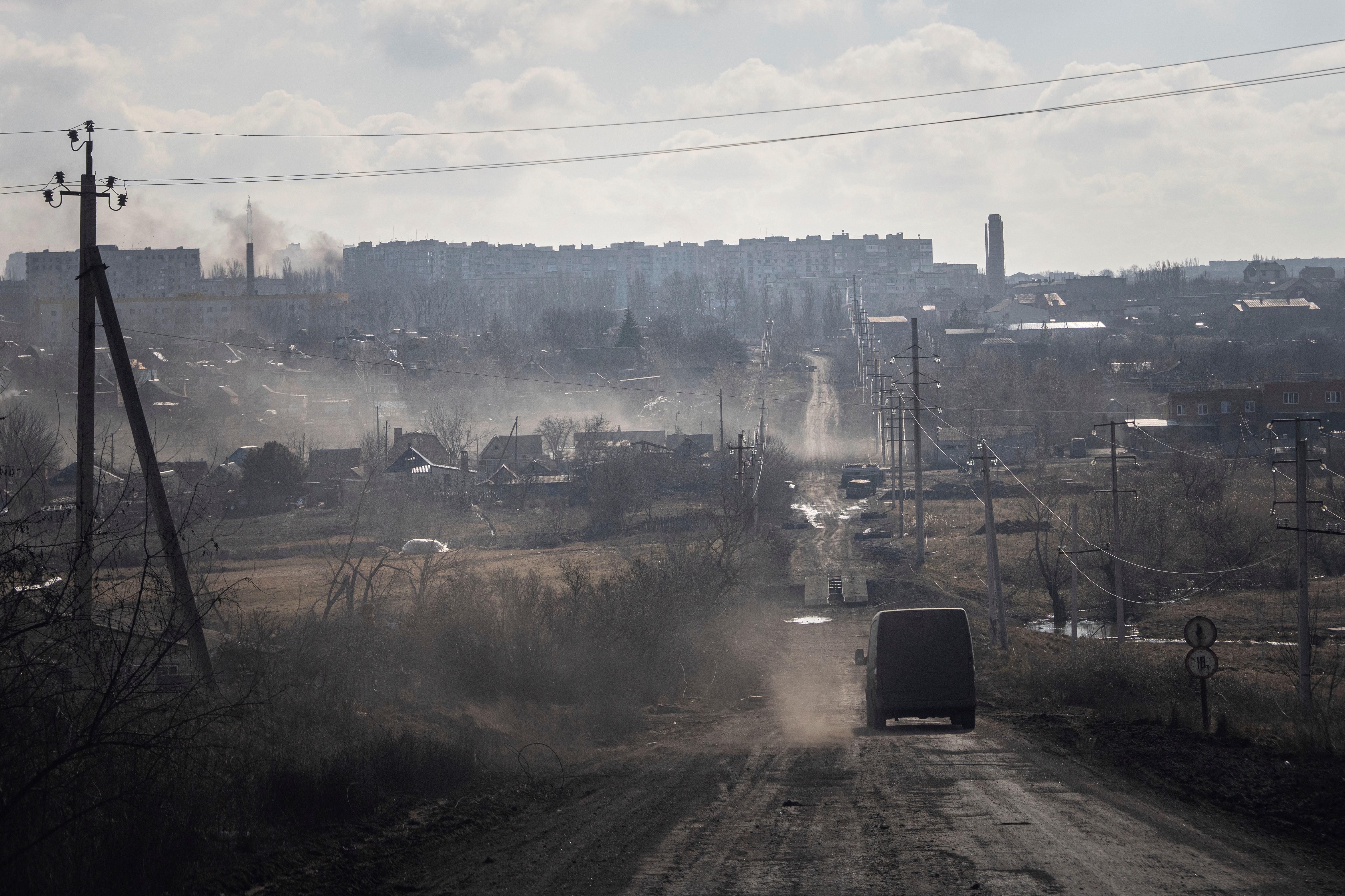 A Ukrainian police van drives on the highway for evacuation civilians in Khromove near Bakhmut, Donetsk region, Saturday, March 4, 2023 (AP Photo/Evgeniy Maloletka)