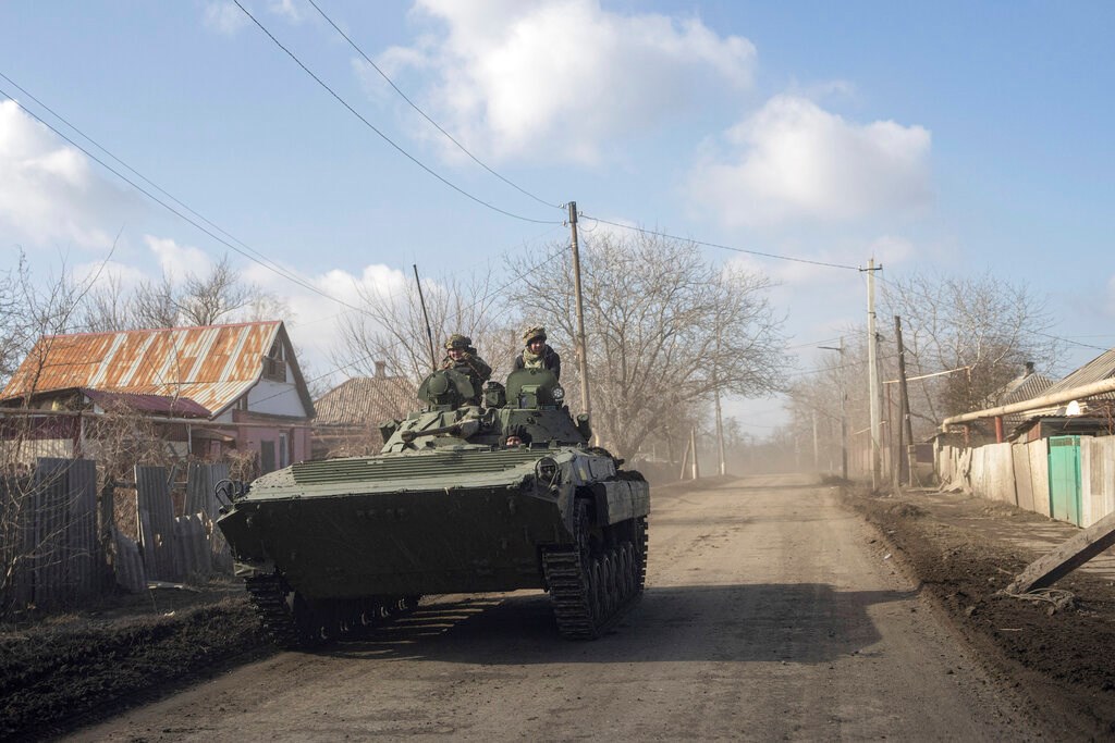 A Ukrainian APC drives towards frontline positions near Bakhmut, Ukraine, Saturday, March 4, 2023 (AP Photo/Evgeniy Maloletka)
