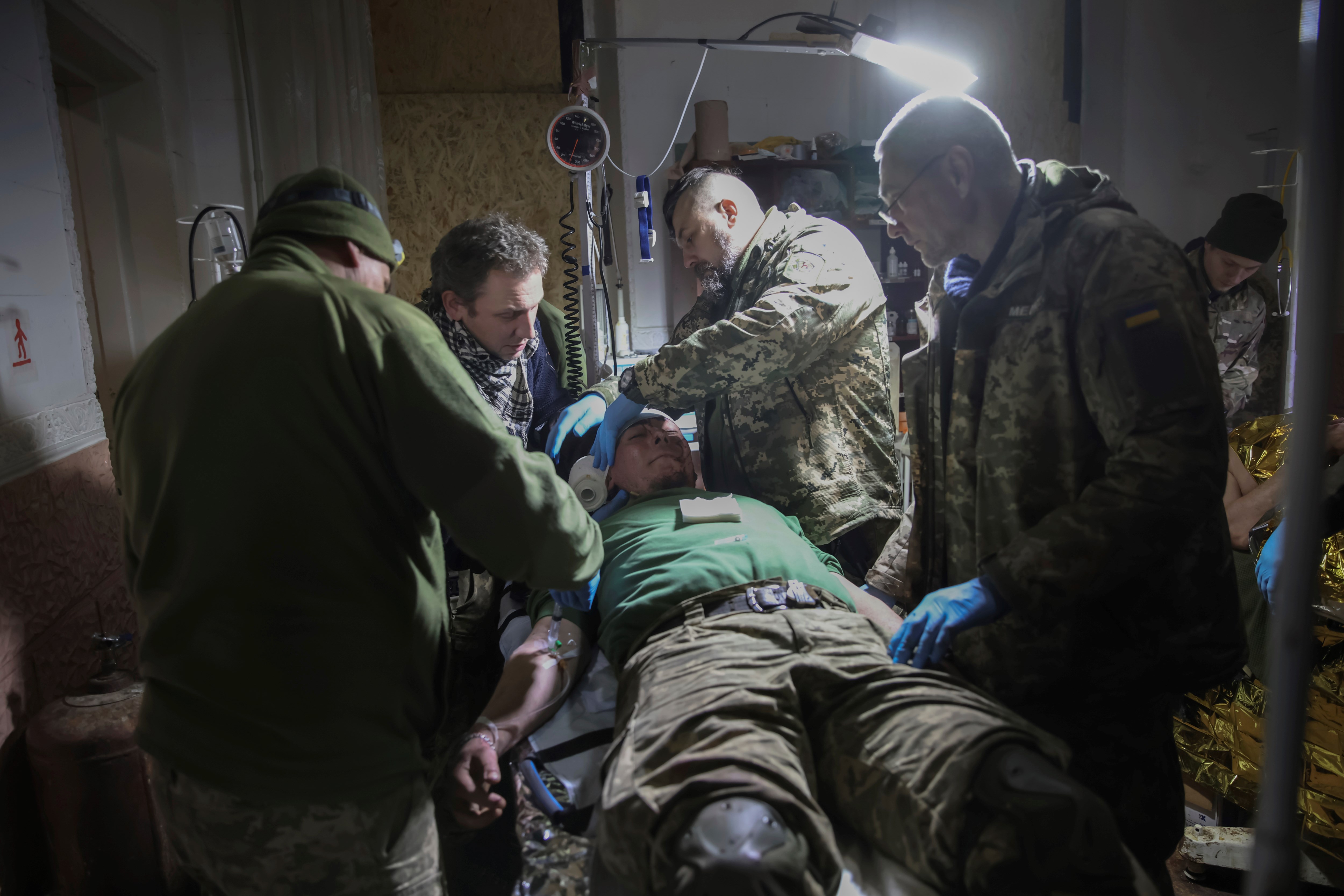 Medics give the first aid to a wounded Ukrainian soldier near Bakhmut, the site of the heaviest battles with the Russian troops, Donetsk region, Monday, Feb. 27, 2023 (AP Photo/Yevhen Titov)