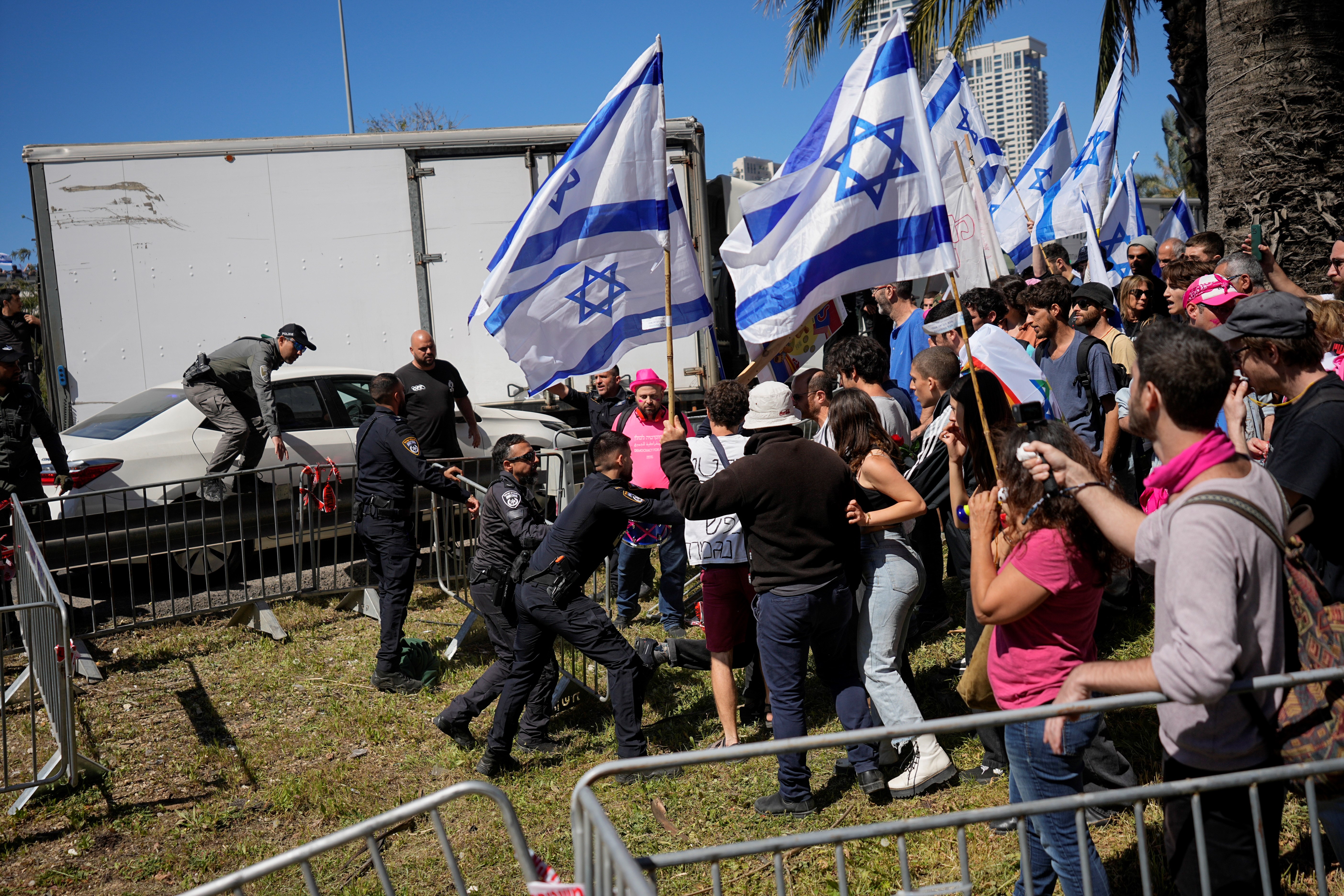 Israeli police scuffle with protesters as they try to block a main road to protest against plans by Prime Minister Benjamin Netanyahu's new government to overhaul the judicial system, in Tel Aviv, Israel, Thursday, March 9, 2023 (AP).
