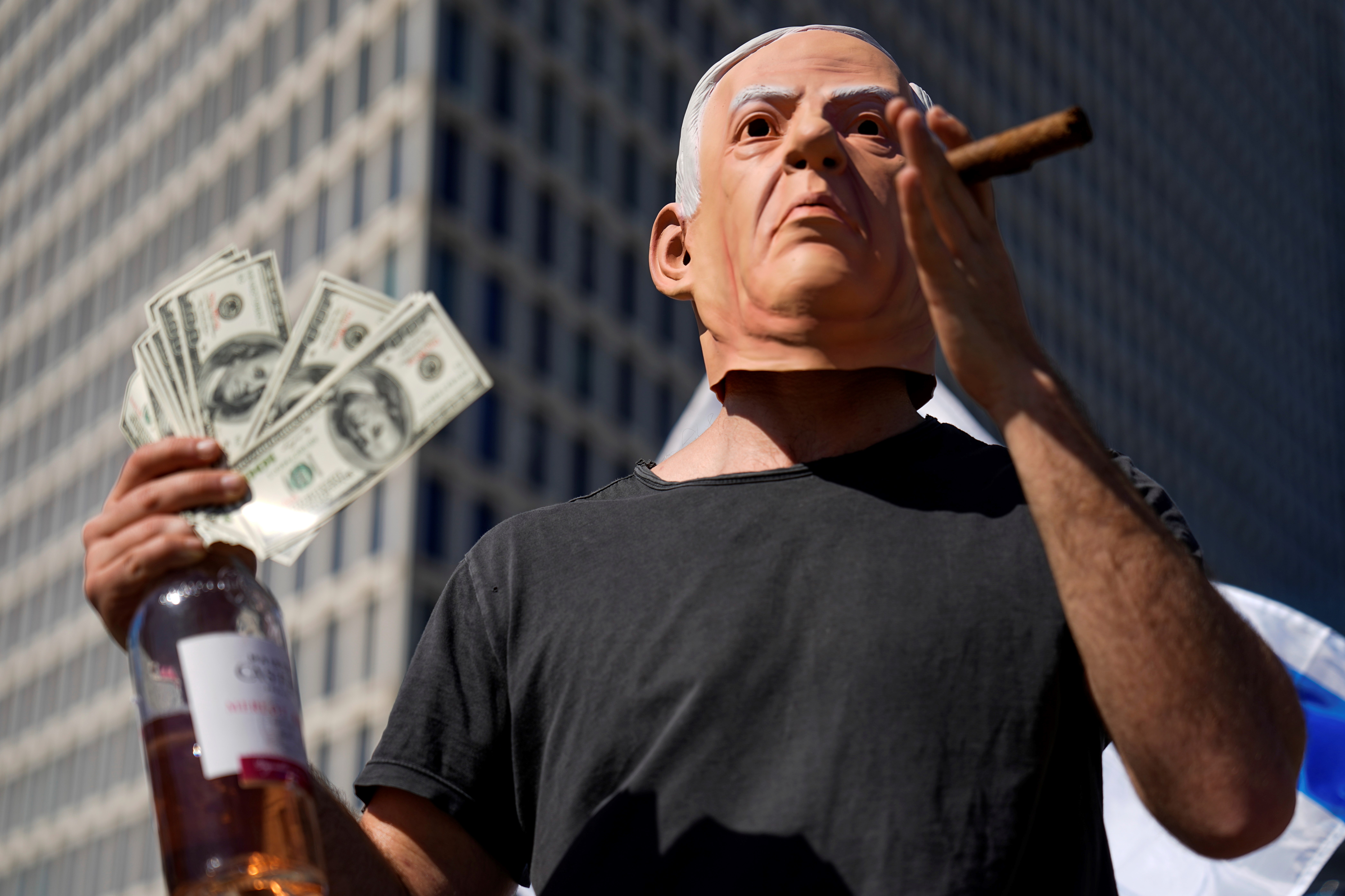 An Israeli demonstrator wears a mask depicting Israeli Prime Minister Benjamin Netanyahu during a protest against plans by his government to overhaul the judicial system, in Tel Aviv, Israel, Thursday, March 9, 2023 (AP).