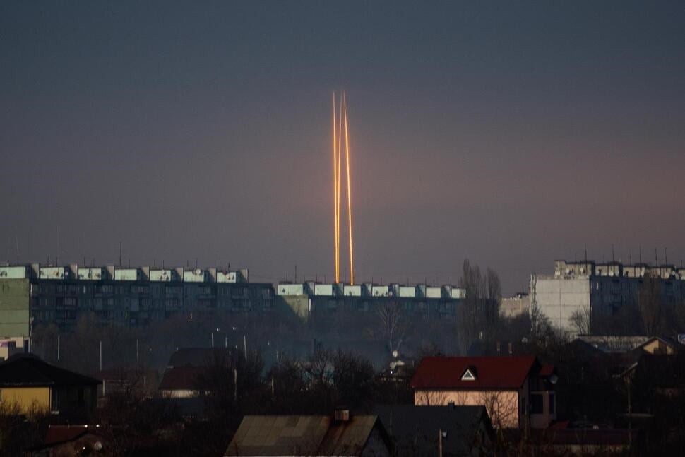 Three Russian rockets that targeted Ukraine launch from Russia's Belgorod region are seen at dawn in Kharkov, Ukraine, March 9, 2023 (AP).