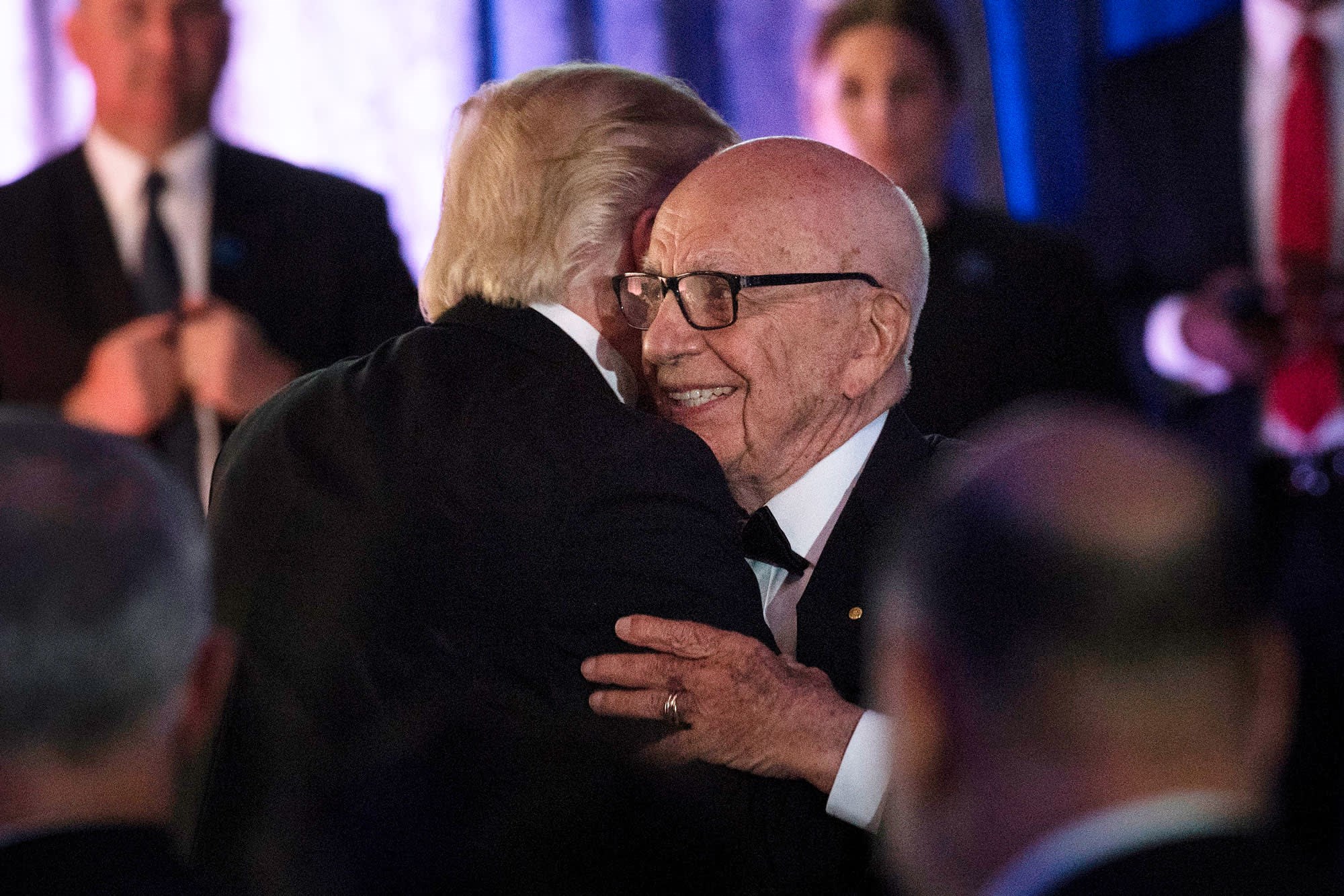 Rupert Murdoch and Donald Trump embracing at during a dinner to commemorate the 75th anniversary of the Battle of the Coral Sea during WWII onboard the Intrepid Sea, Air and Space Museum May 4, 2017 in New York (AFP)