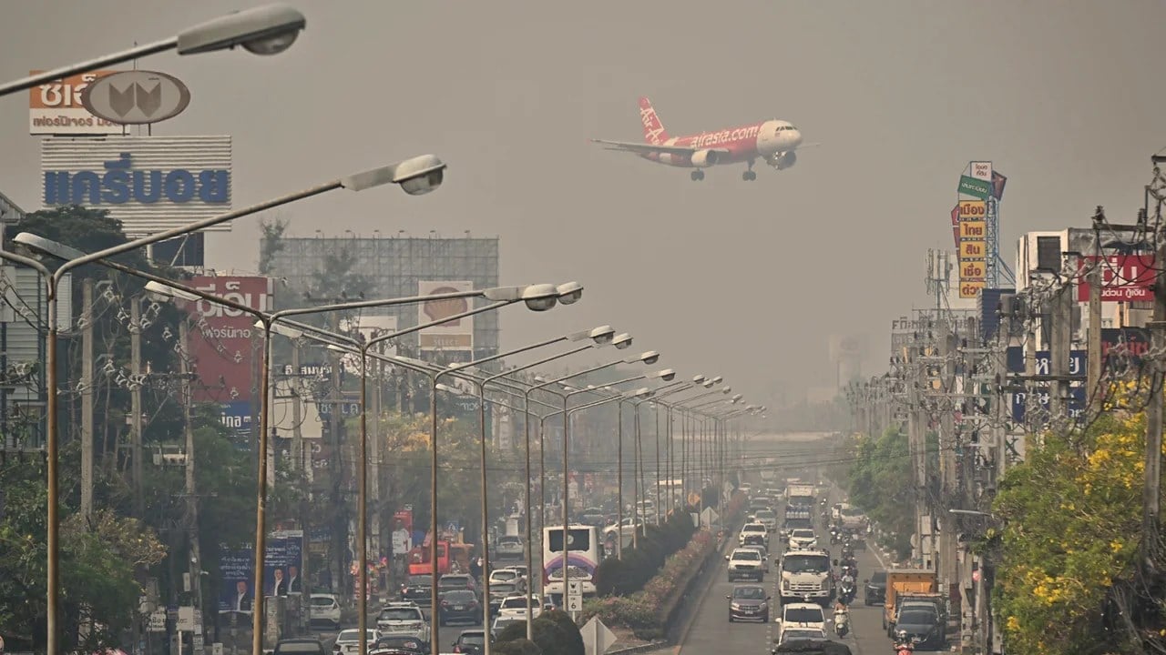An Air Asia plane prepares to land in Chiang Mai International Airport in the heavily polluted but busy Thai city, 10 April 2023. (AFP)