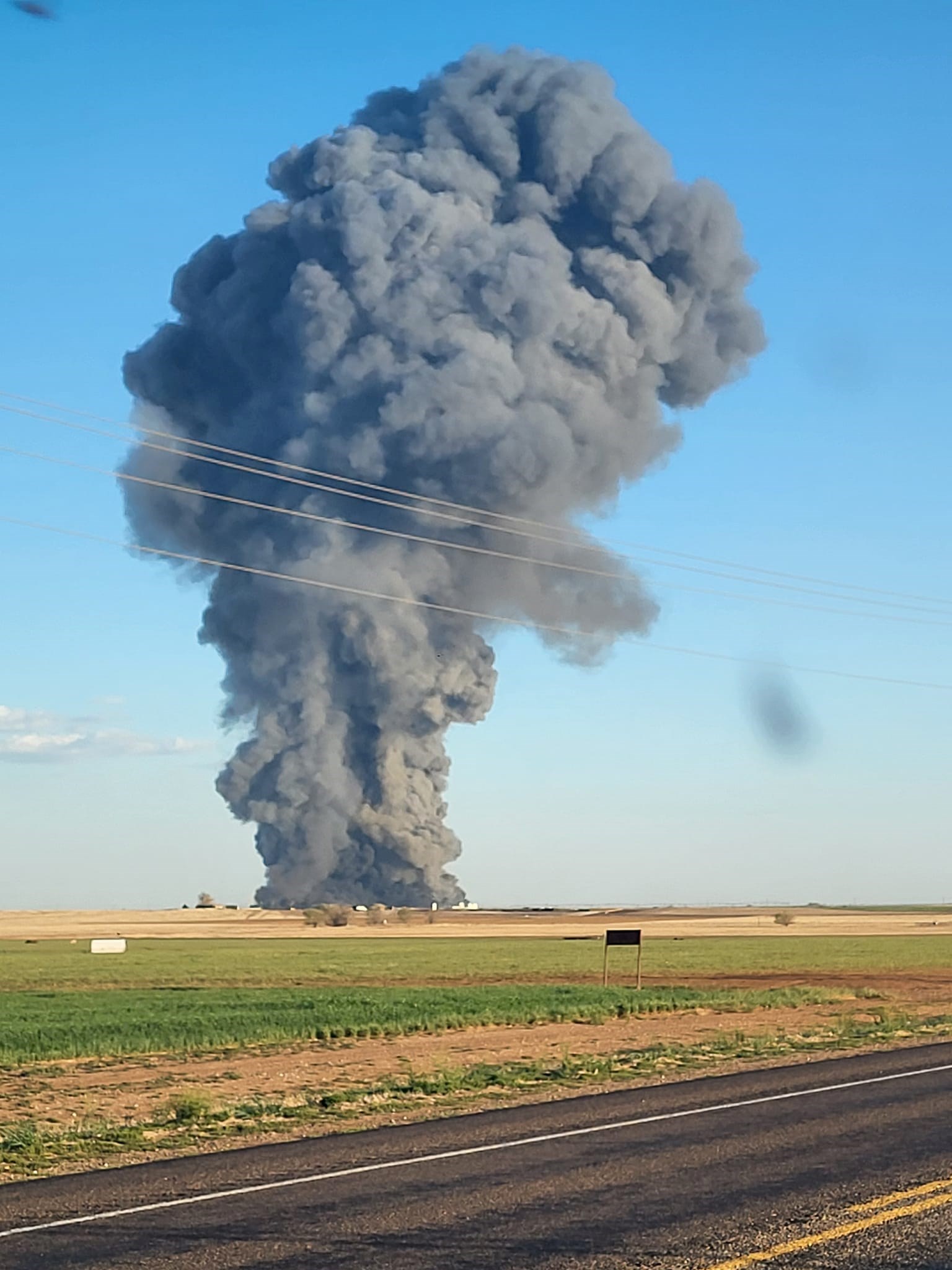 A black cloud erupts from the Southfork Dairy Farm after an explosion killed 18,000 cattle, Dimmitt, Texas Panhandle, United States, 10 April 2023. (Castro County Sheriff's Office/Facebook)