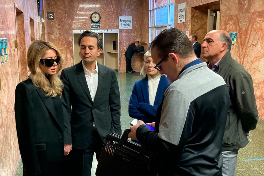 Khazar Elyassnia stands alongside her husband Dino Elyassnia, at the Hall of Justice in San Francisco where her brother was scheduled to appear after being charged with the murder of Bob Lee on Friday, 14 April 2023 . (AP) 