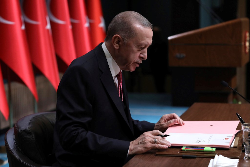 Turkey's President Recep Tayyip Erdogan reads his decision confirming the election date, in Ankara, Turkey, Friday, March 10, 2023 (AP Photo/Burhan Ozbilici)