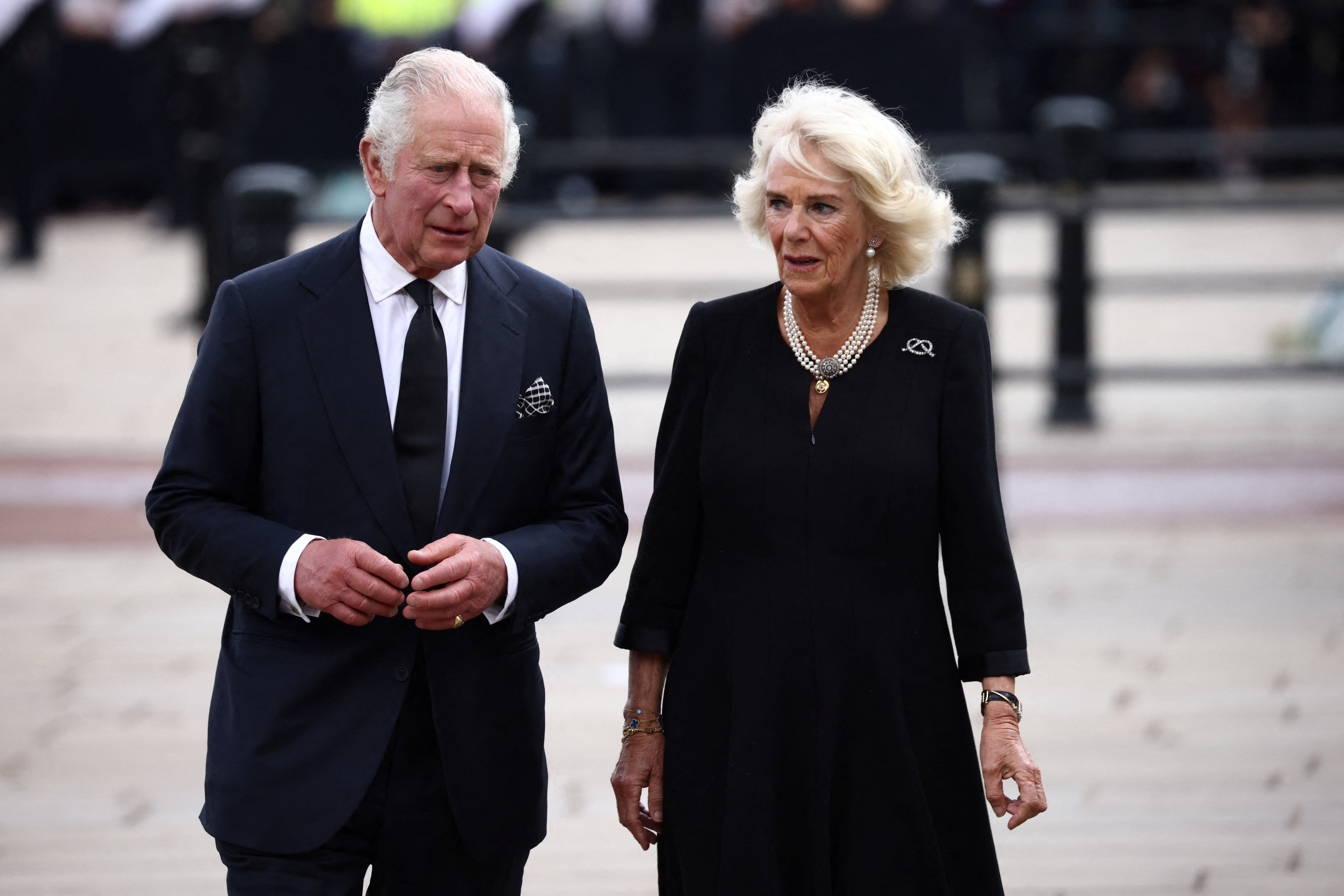 Britain's King Charles and Queen Camilla walk along the fence of Buckingham Palace, following the passing of Britain's Queen Elizabeth, in London, Britain, September 9, 2022 (Reuters)