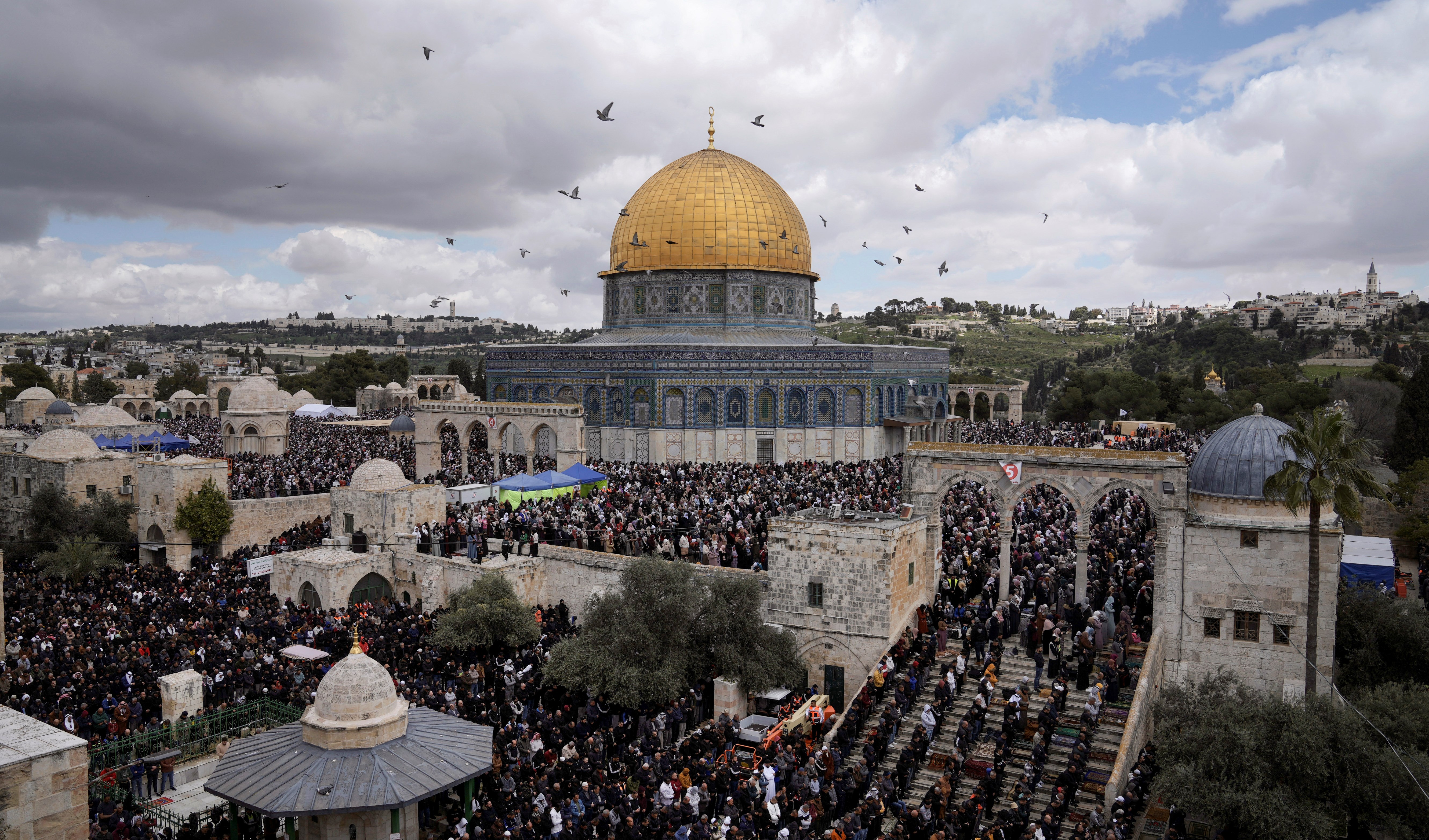 Muslim worshippers perform Friday prayers outside the Dome of Rock Mosque at the Al-Aqsa Mosque compound in the Old City of Jerusalem during the Muslim holy month of Ramadan, March 31, 2023 (AP).