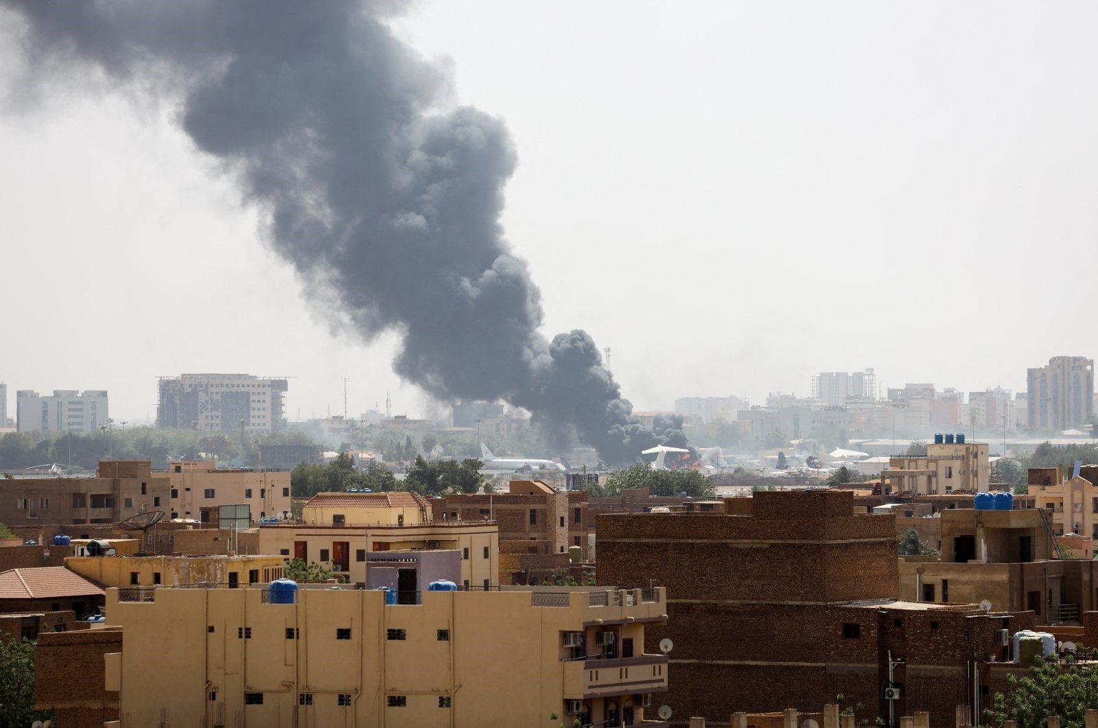 Smoke rises from burning aircraft inside Khartoum Airport during clashes between the paramilitary RSF and the army in Khartoum, Sudan, April 17, 2023 (Reuters)