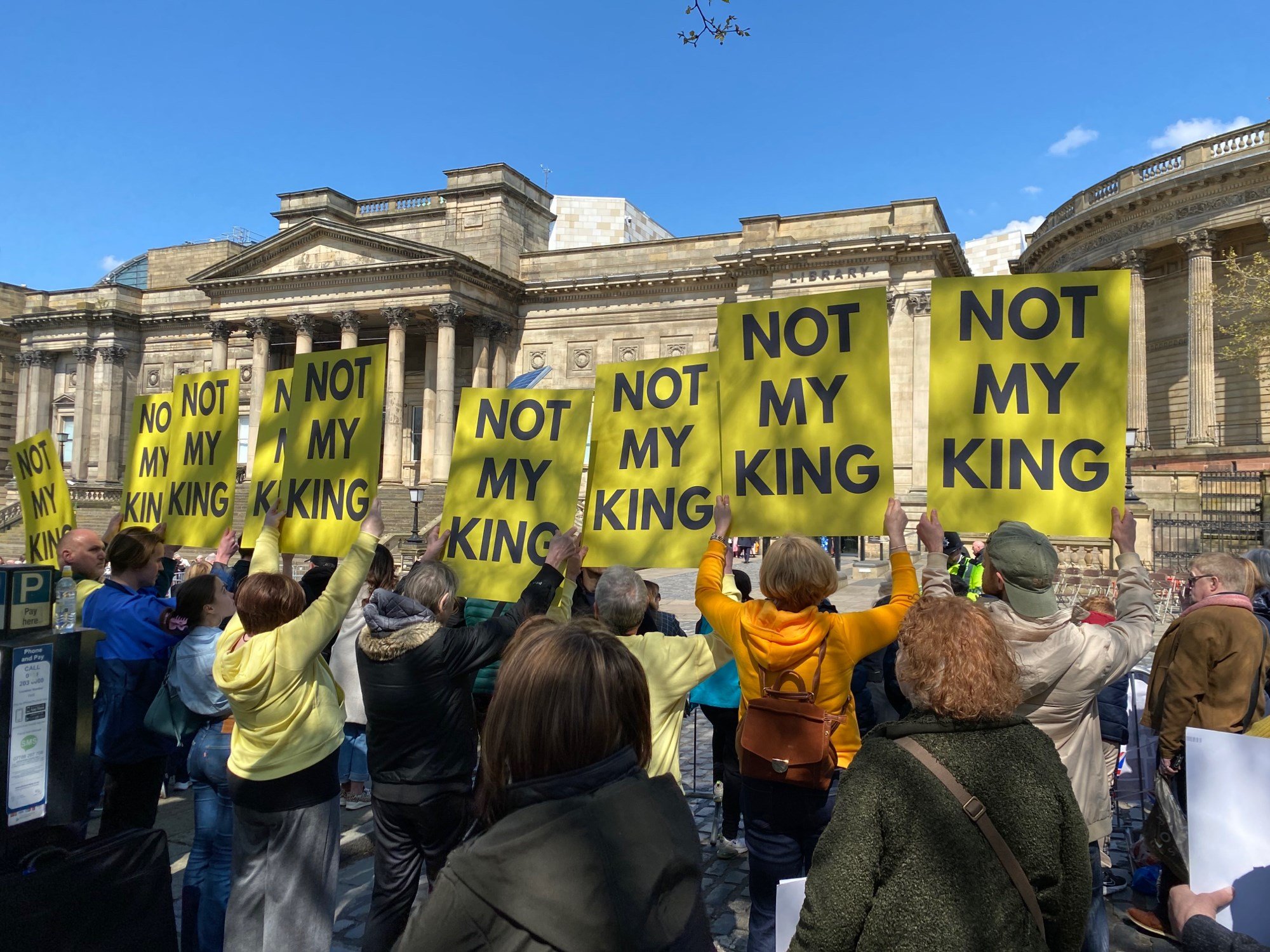 Republic supporters hold up signs that read